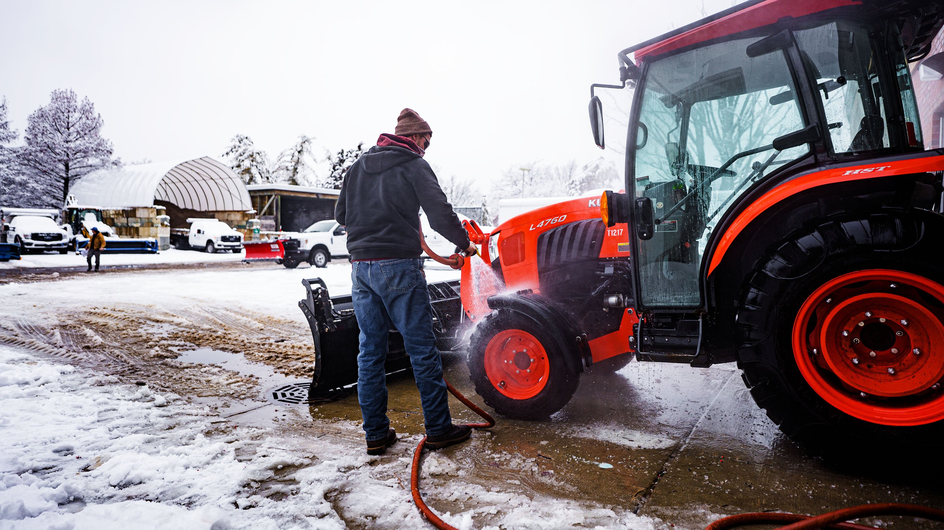 IPF employee cleaning snow plow