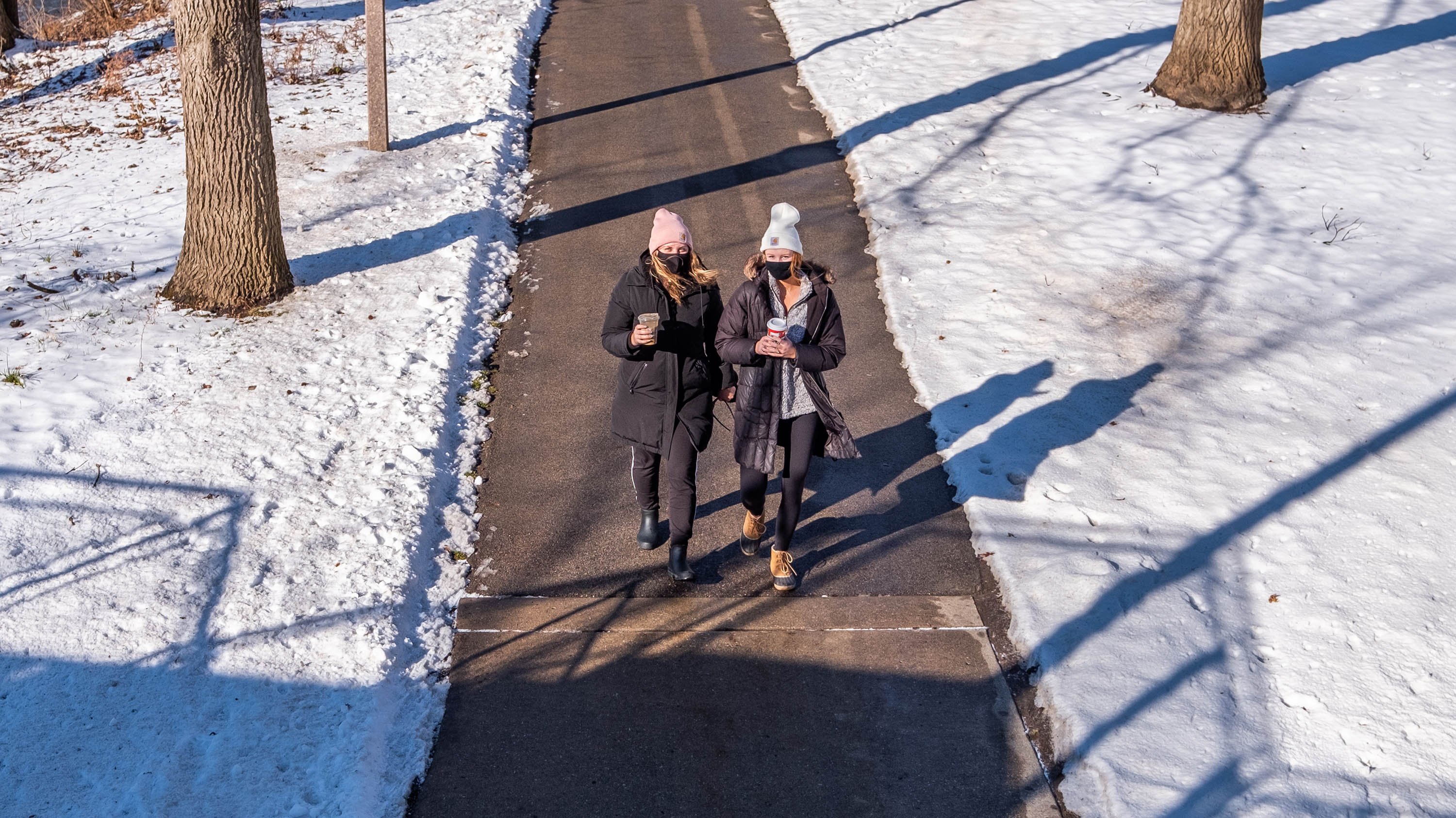 Two students walking on a path