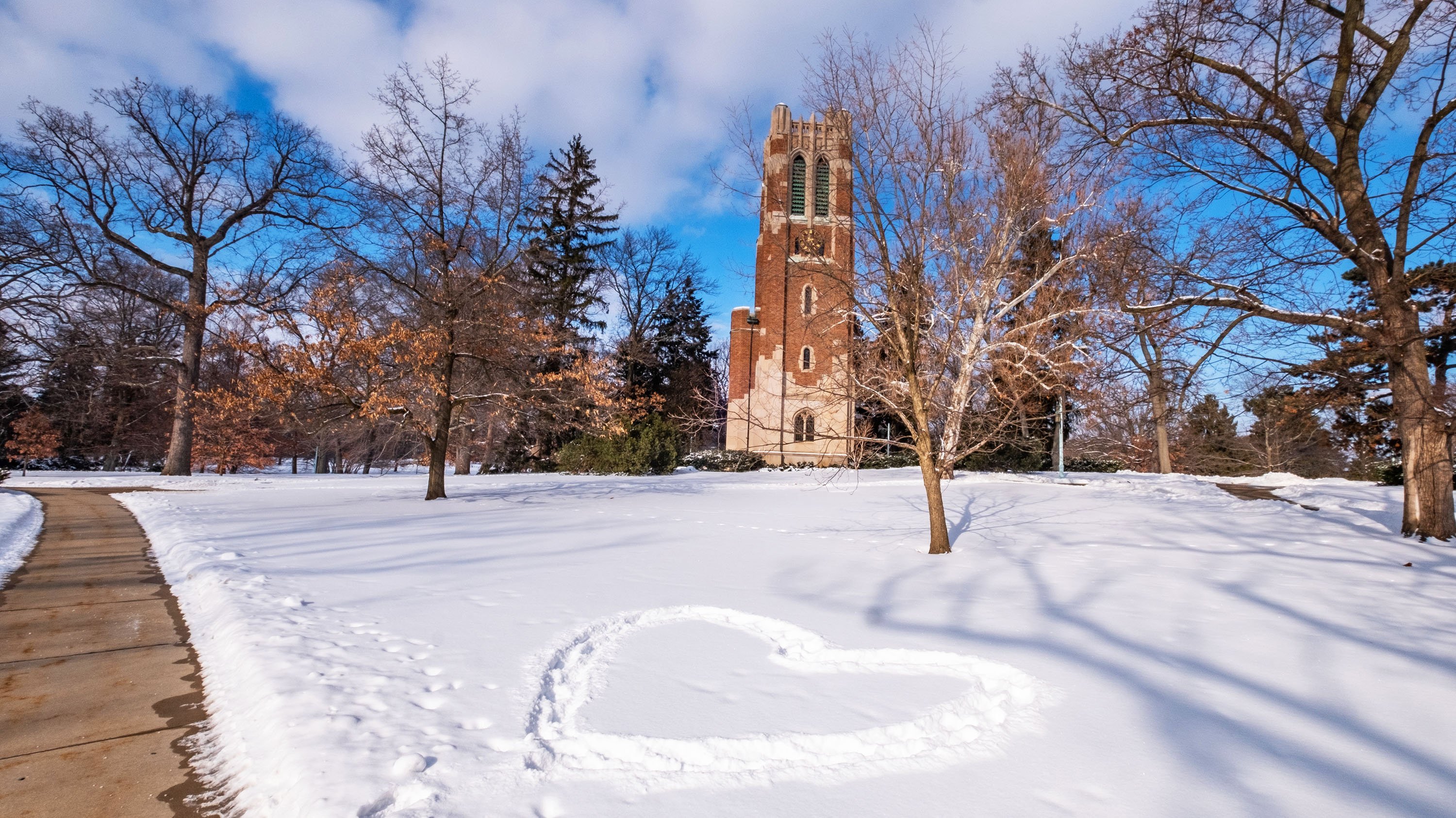 Tracks in the snow forming a heart shape in front of Beaumont tower.