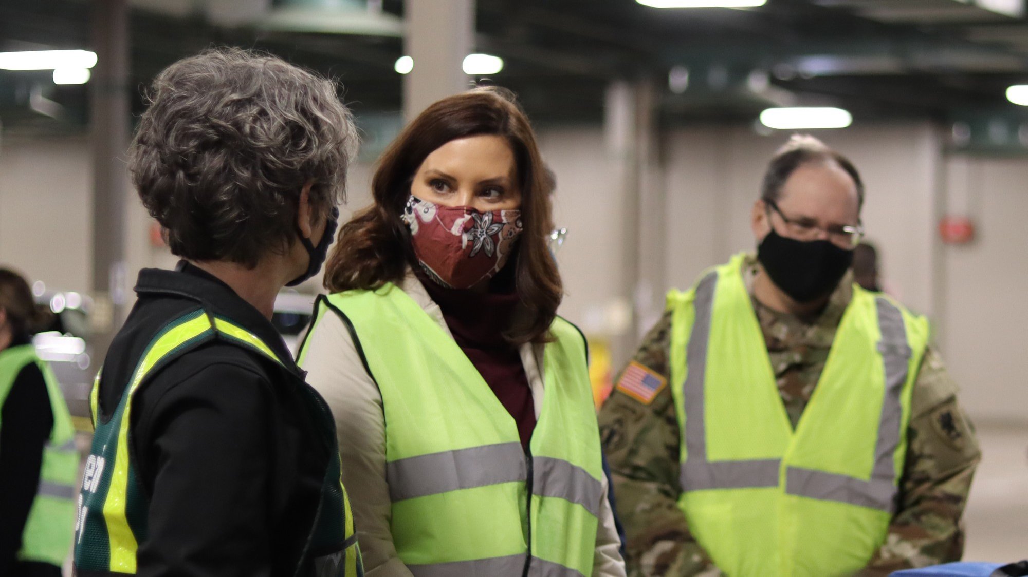 Linda Vail, Gretchen Whitmer, and Paul Rogers in the MSU Pavilion