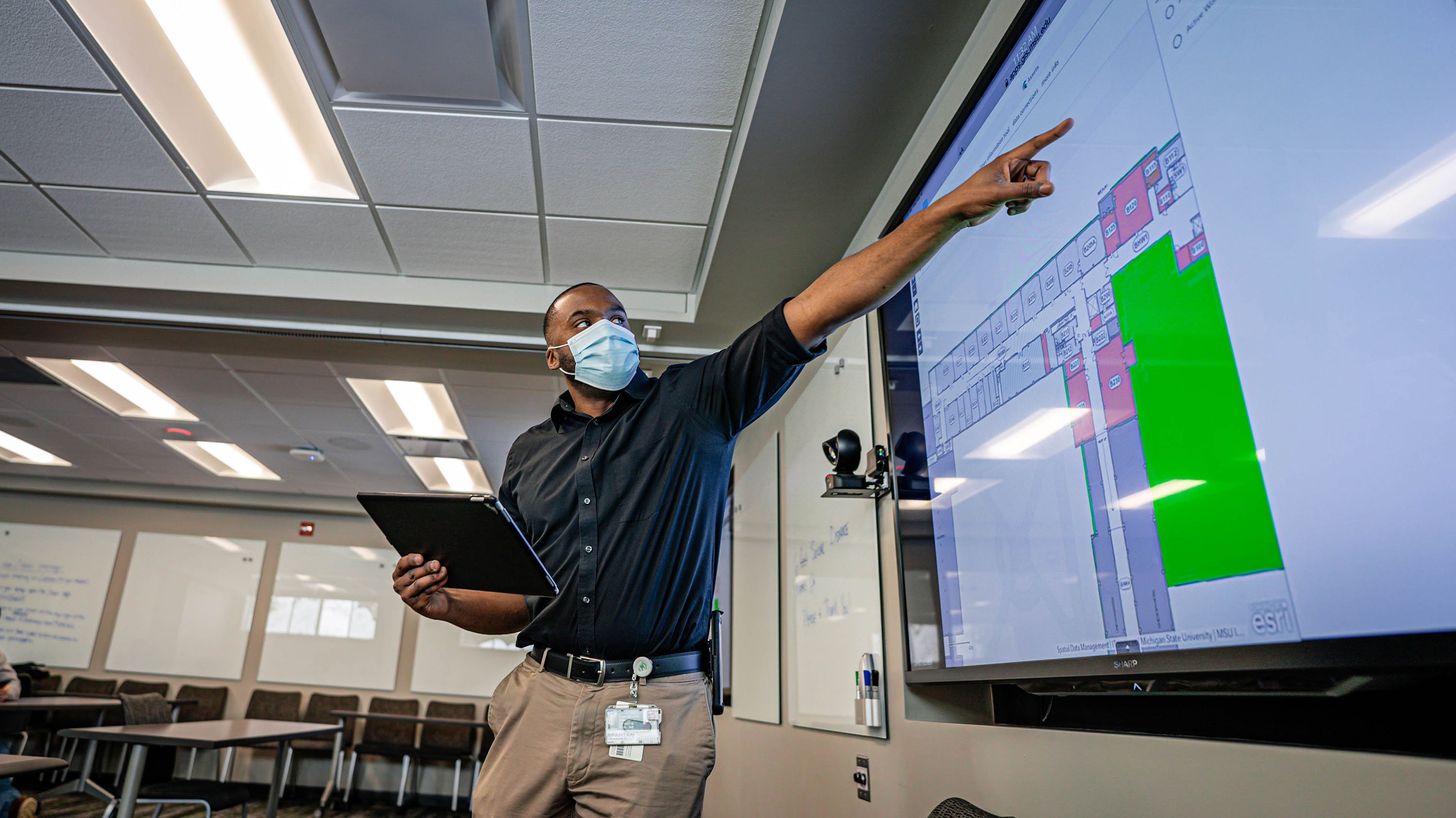 Man gesturing to a screen