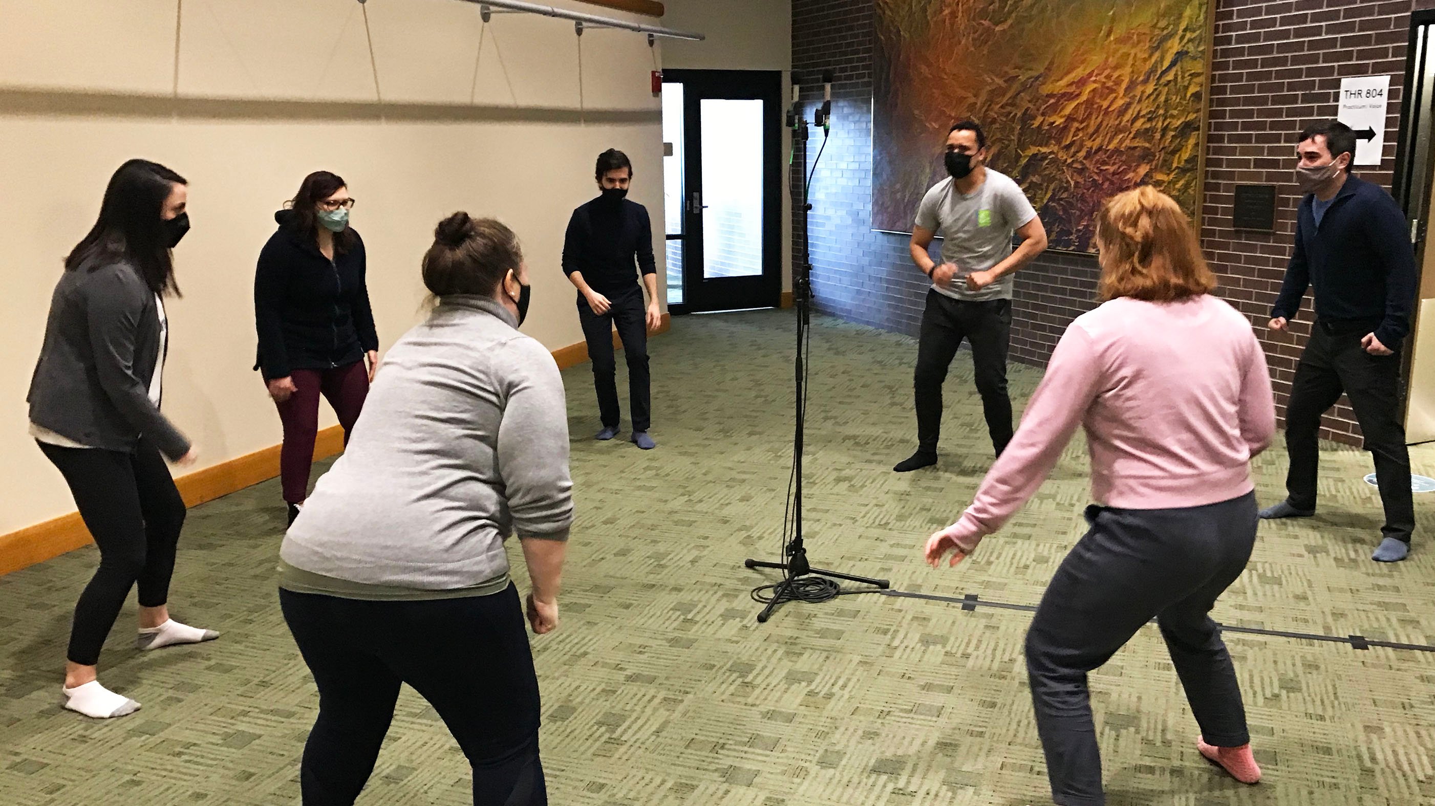 Students performing around a microphone
