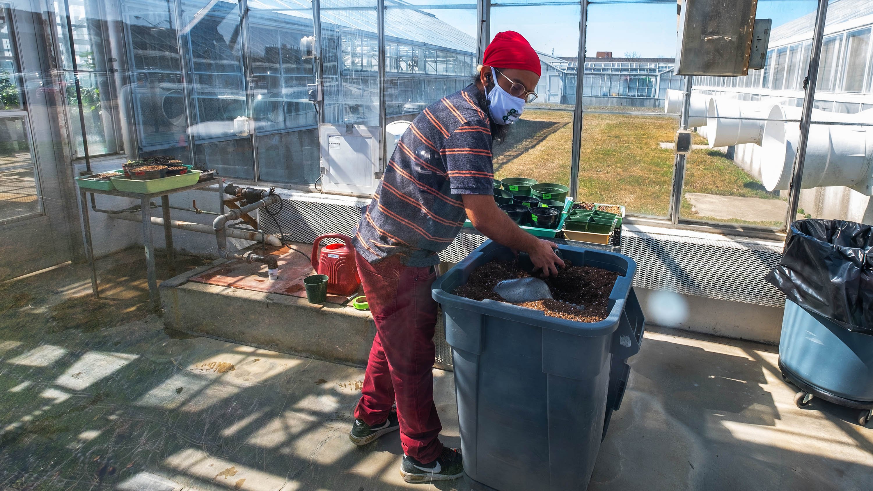 A student putting soil into plant pots