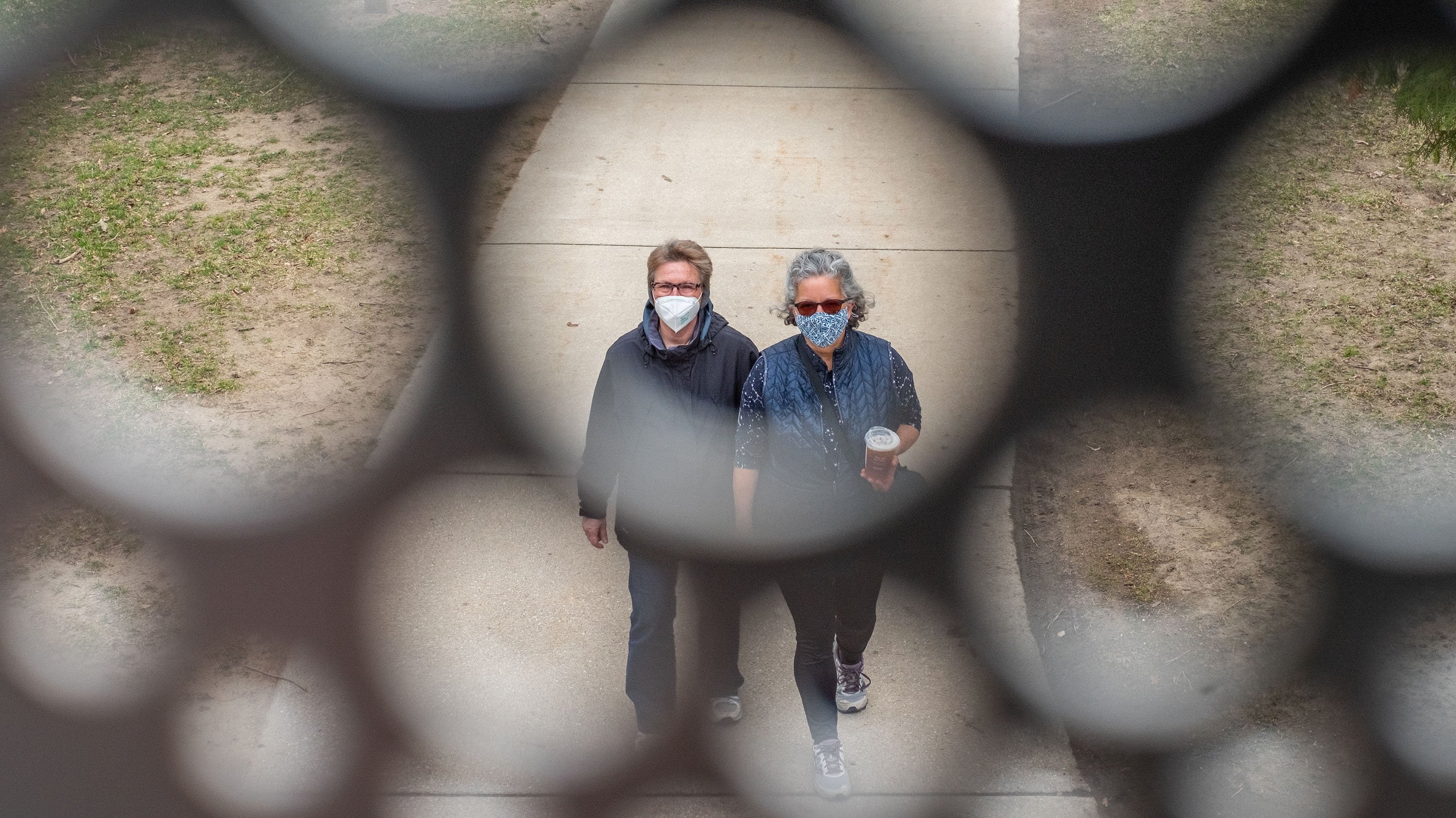 People walking under a bridge