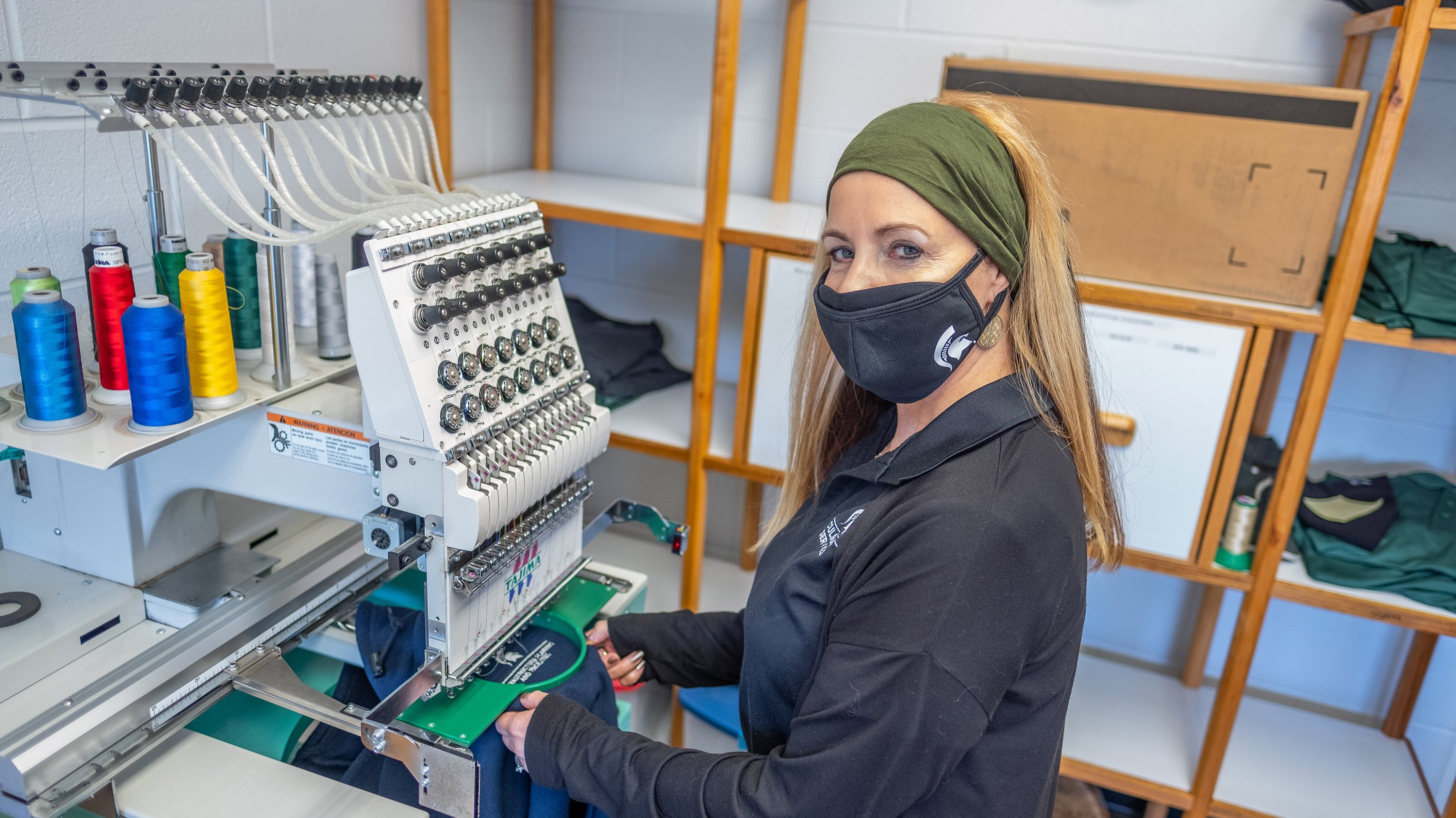 Michell Moench operating an embroidery machine