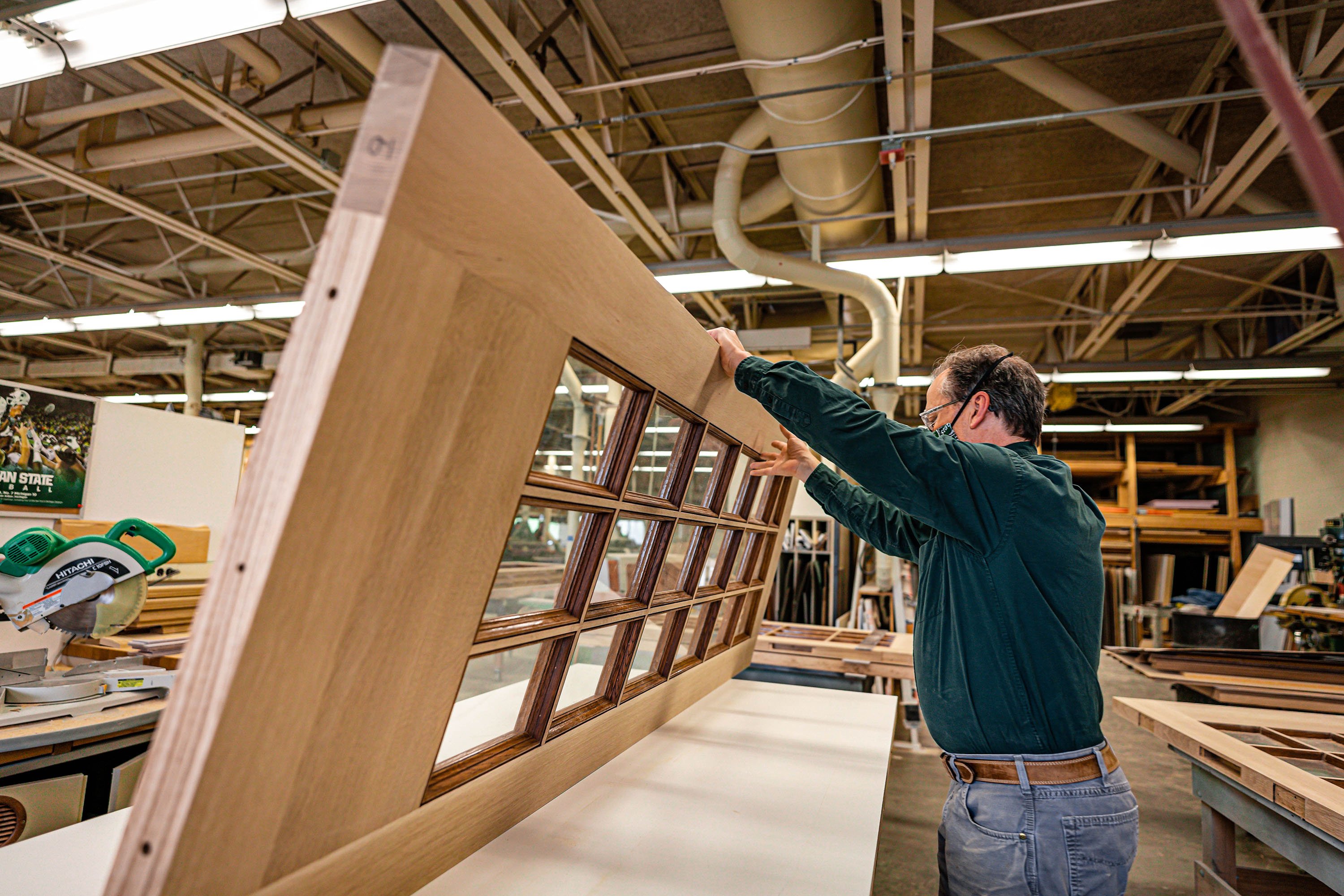 Carpenter working on a door in a workshop