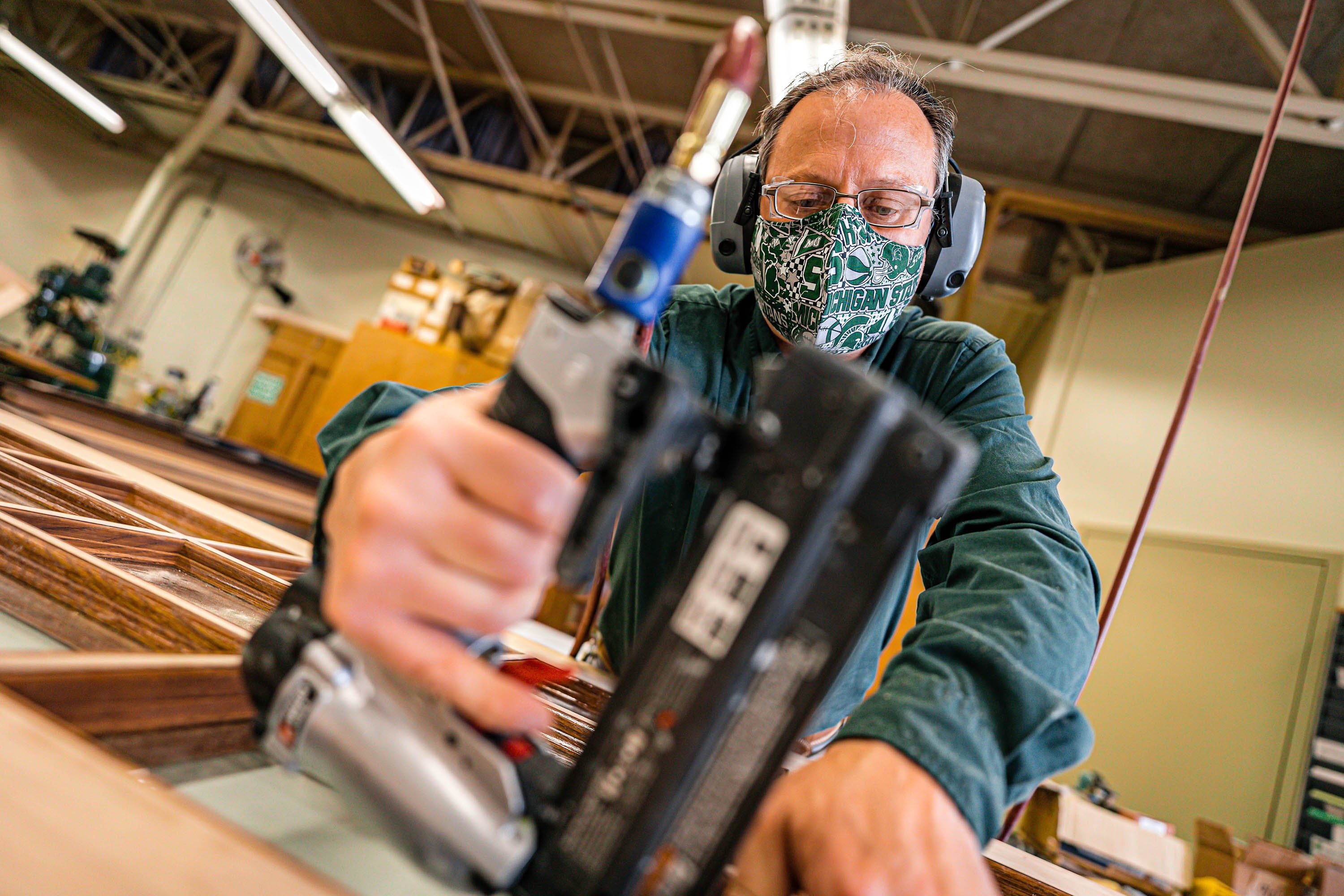 Carpenter using a nail gun