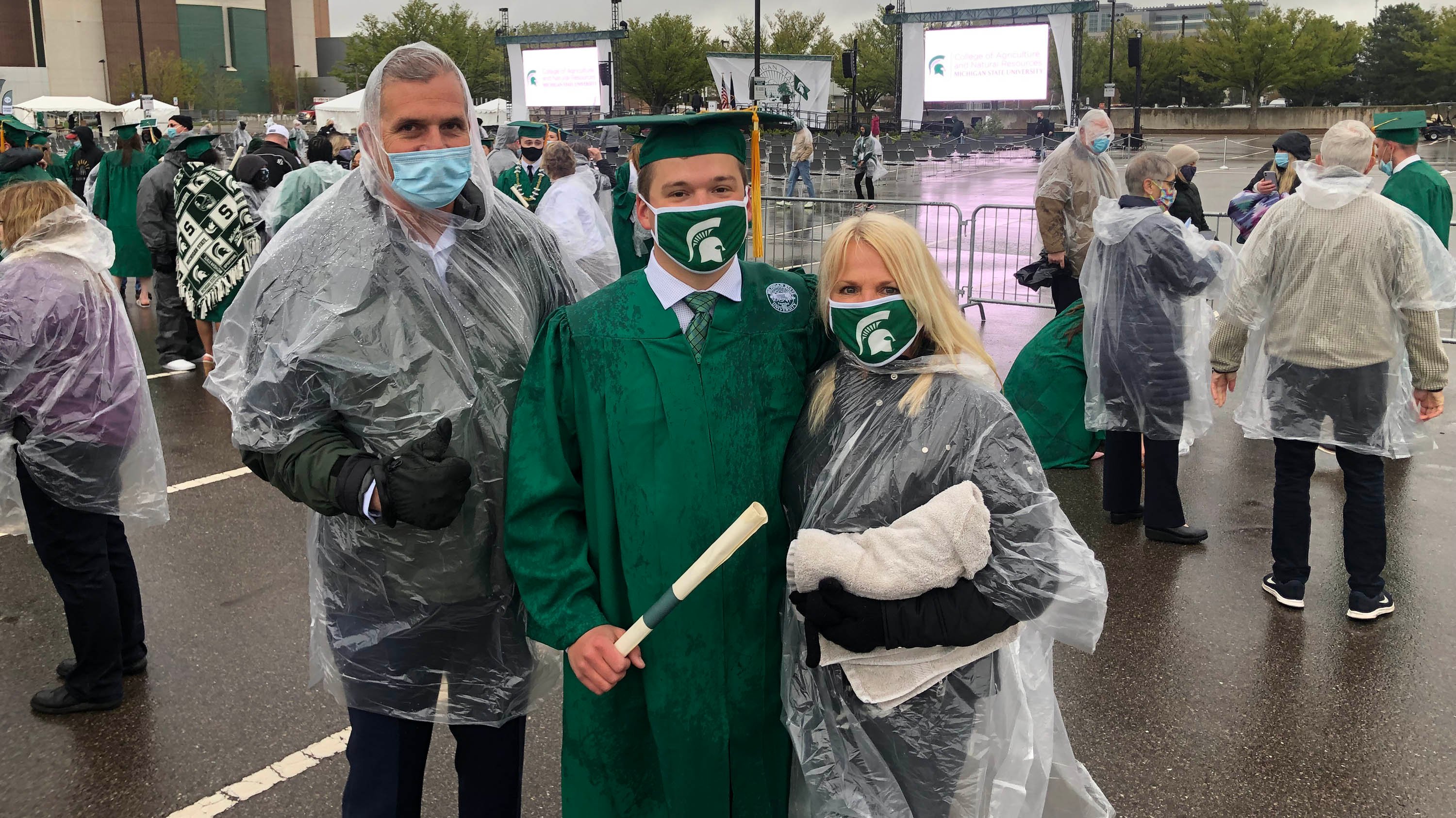 Family posing for a photo during commencement after rainfall