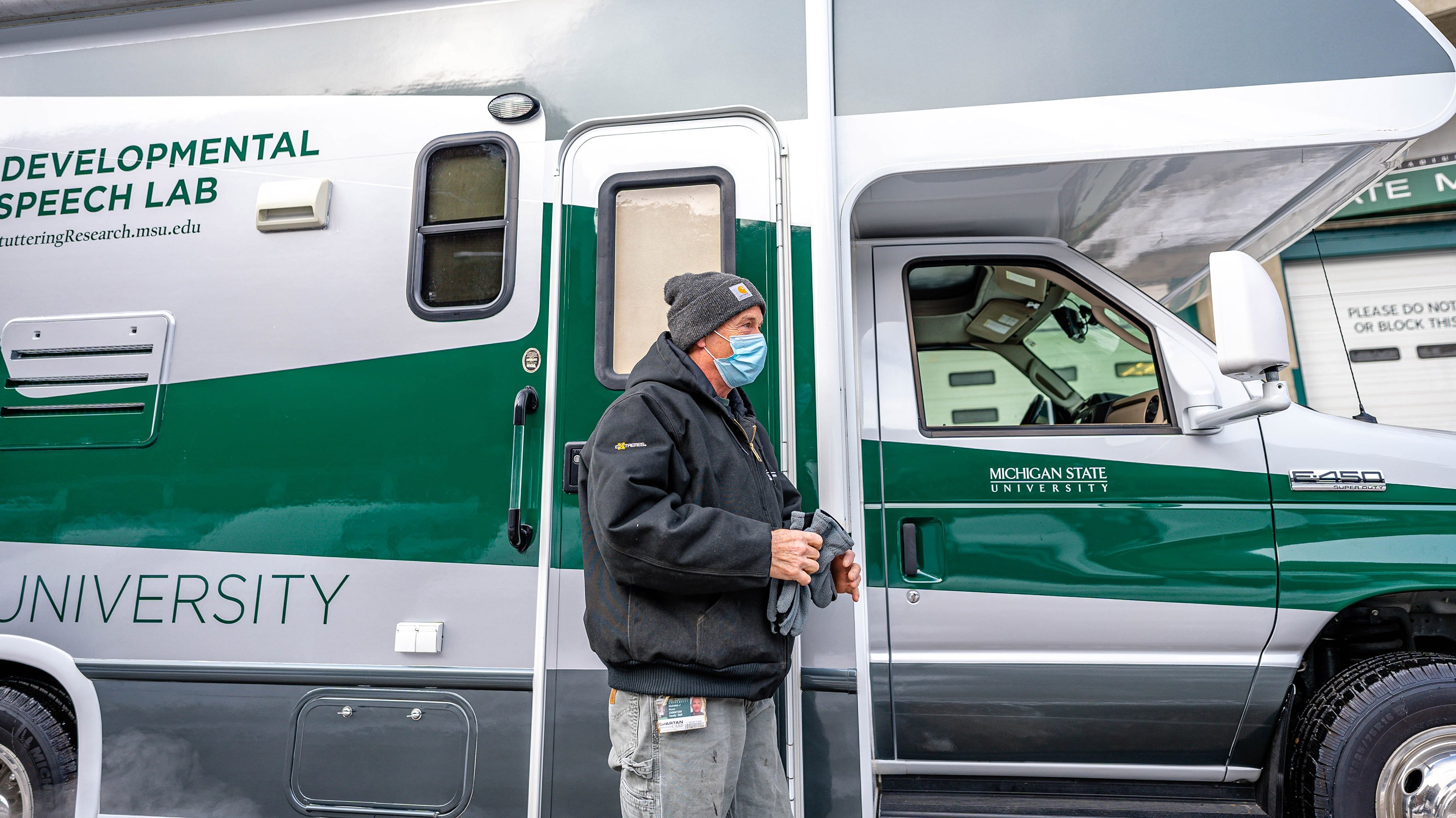 Person standing in front of mobile speech lab RV