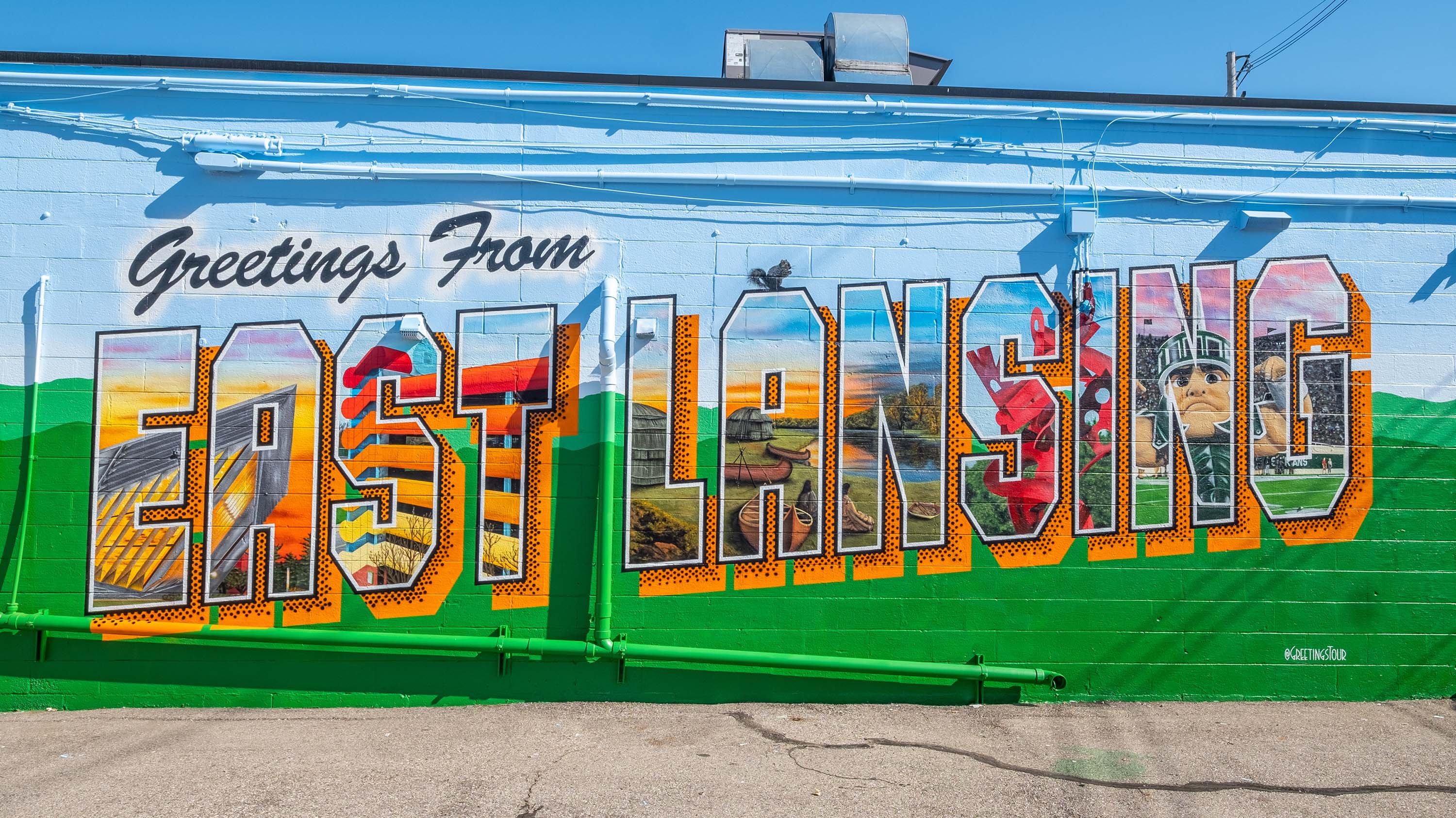 Mural with text 'Greetings from East Lansing'