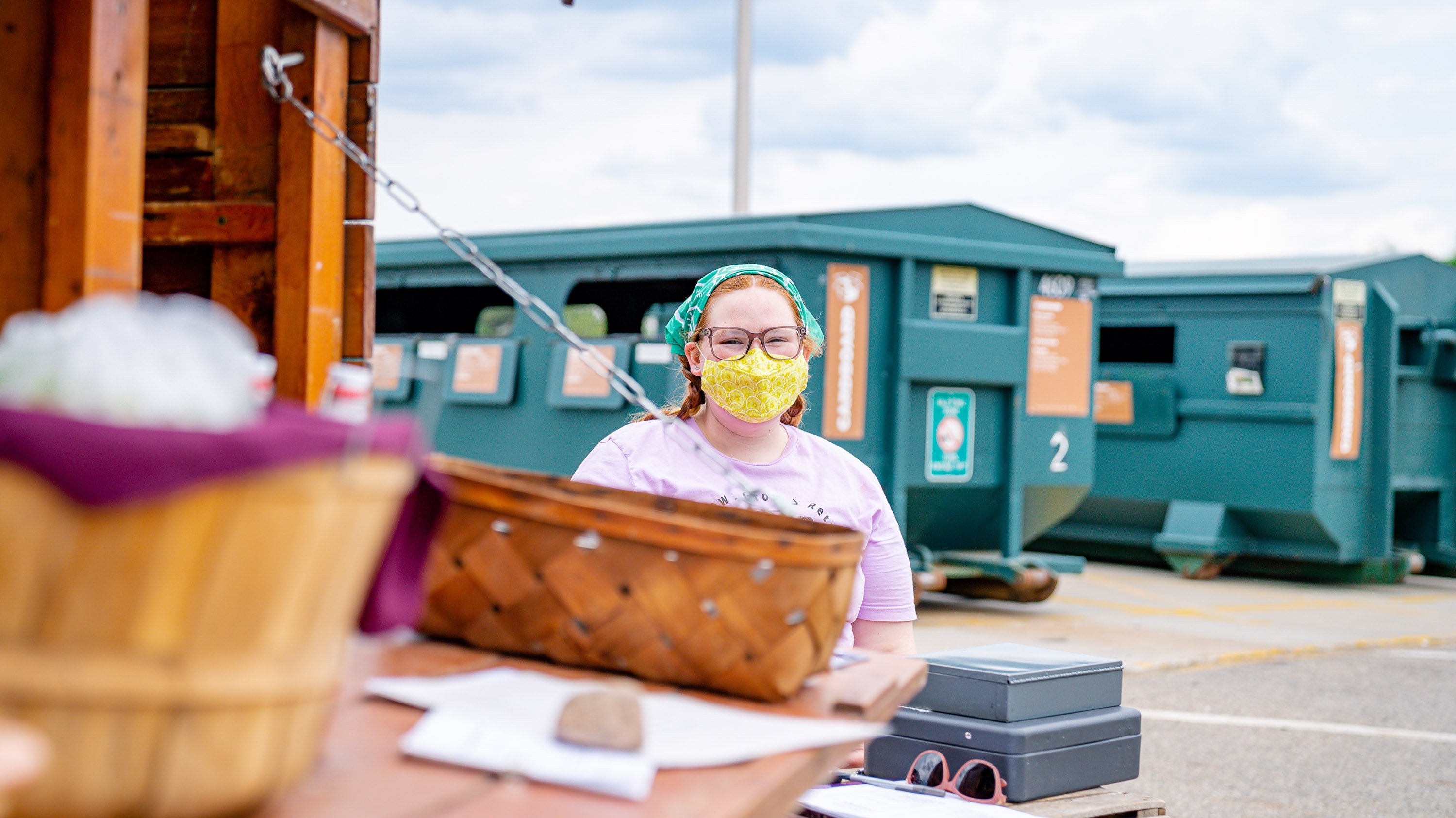 Person working at a farm stand near MSU recycling center