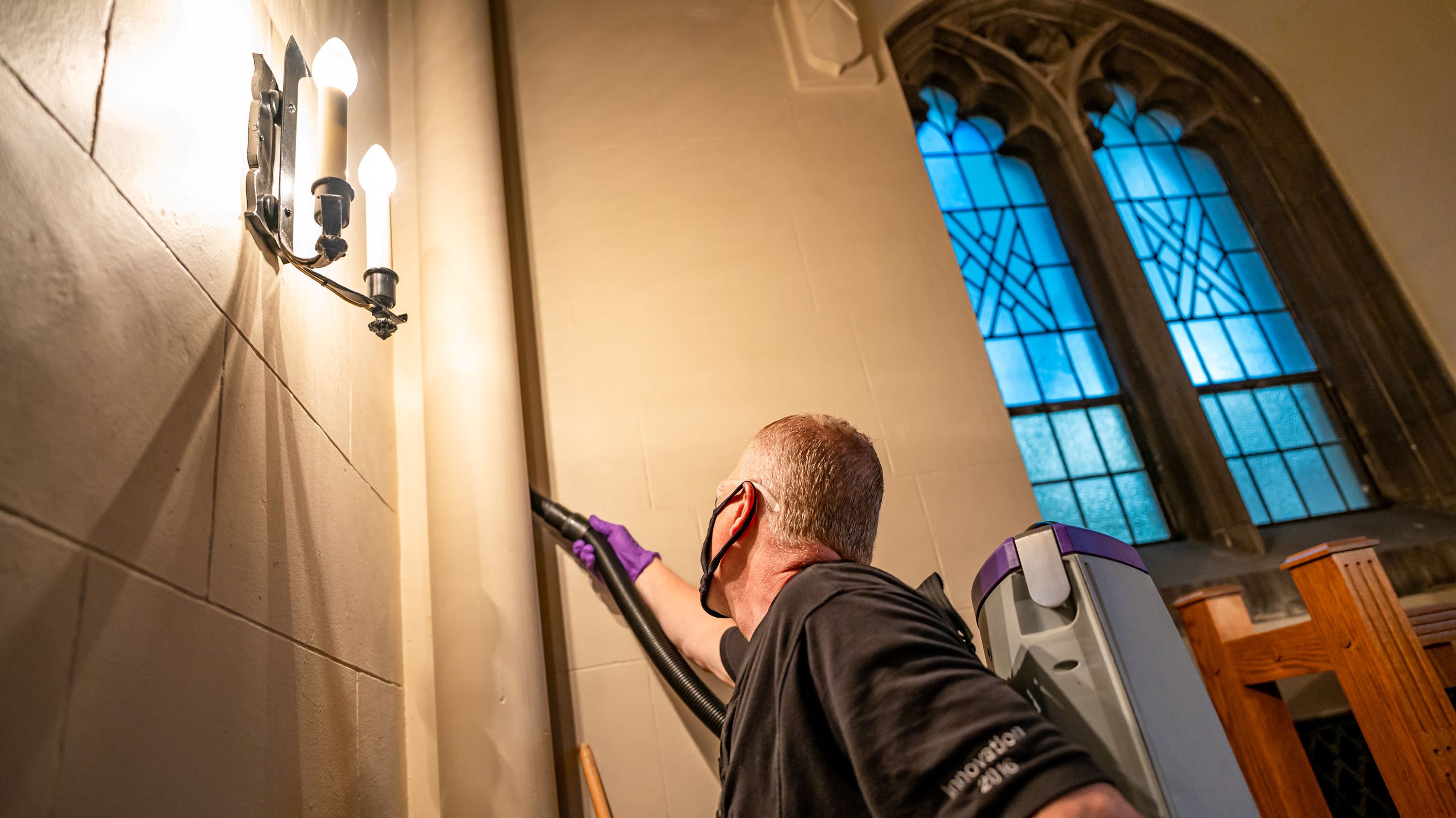 Custodian cleaning inside Beaumont Tower