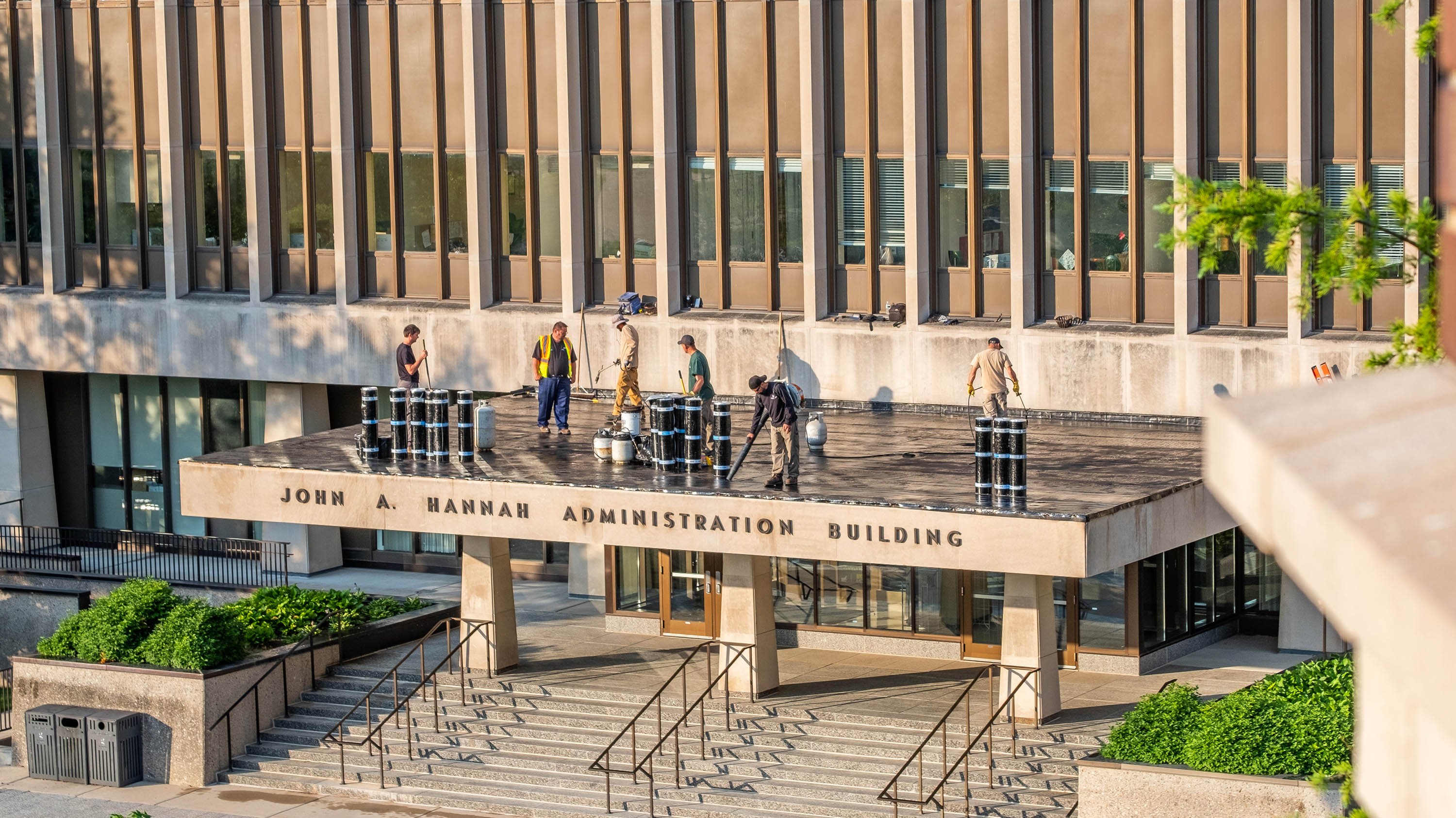 IPF crew on the roof of the entrance of Hannah Admin building
