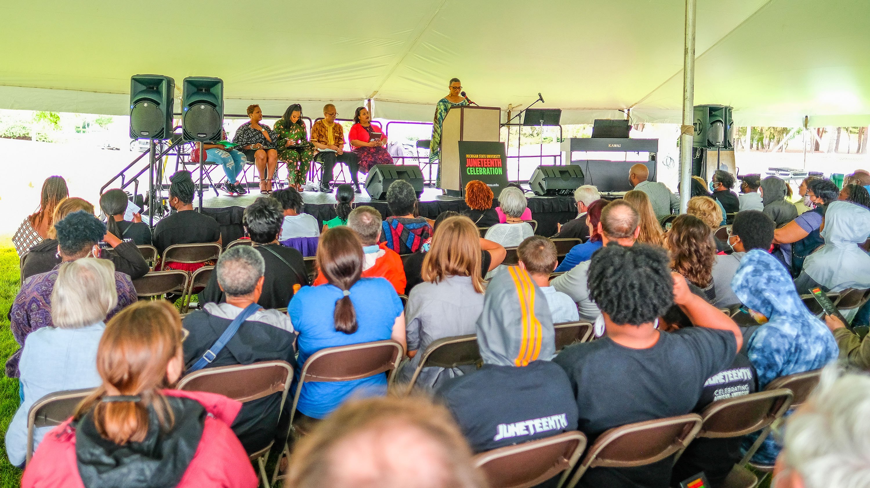 Photo of a speaker and the crowd at the MSU Juneteenth event