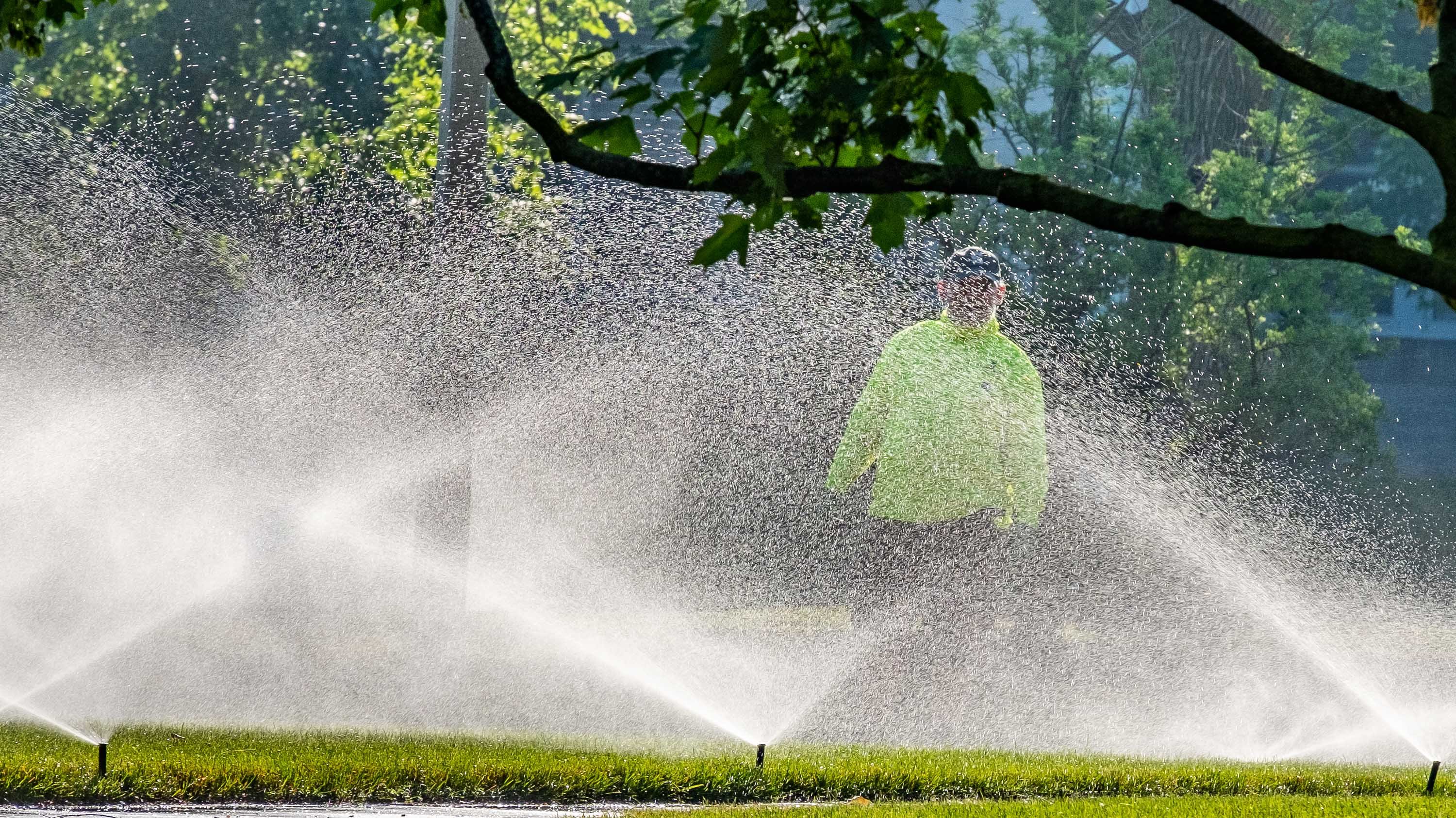 IPF crew member Jim Kane behind sprinkler