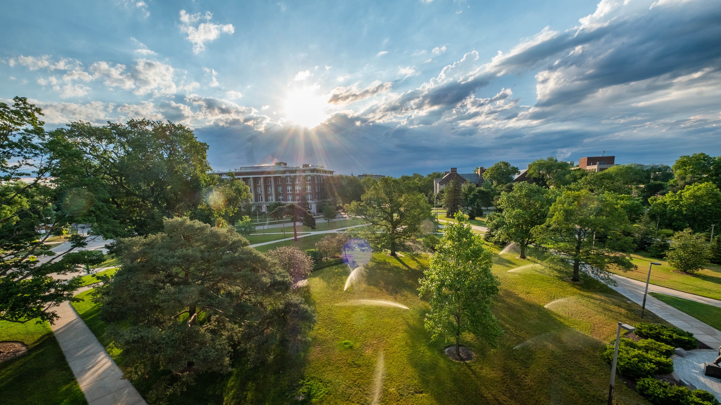 The sun coming out from behind a cloud on campus
