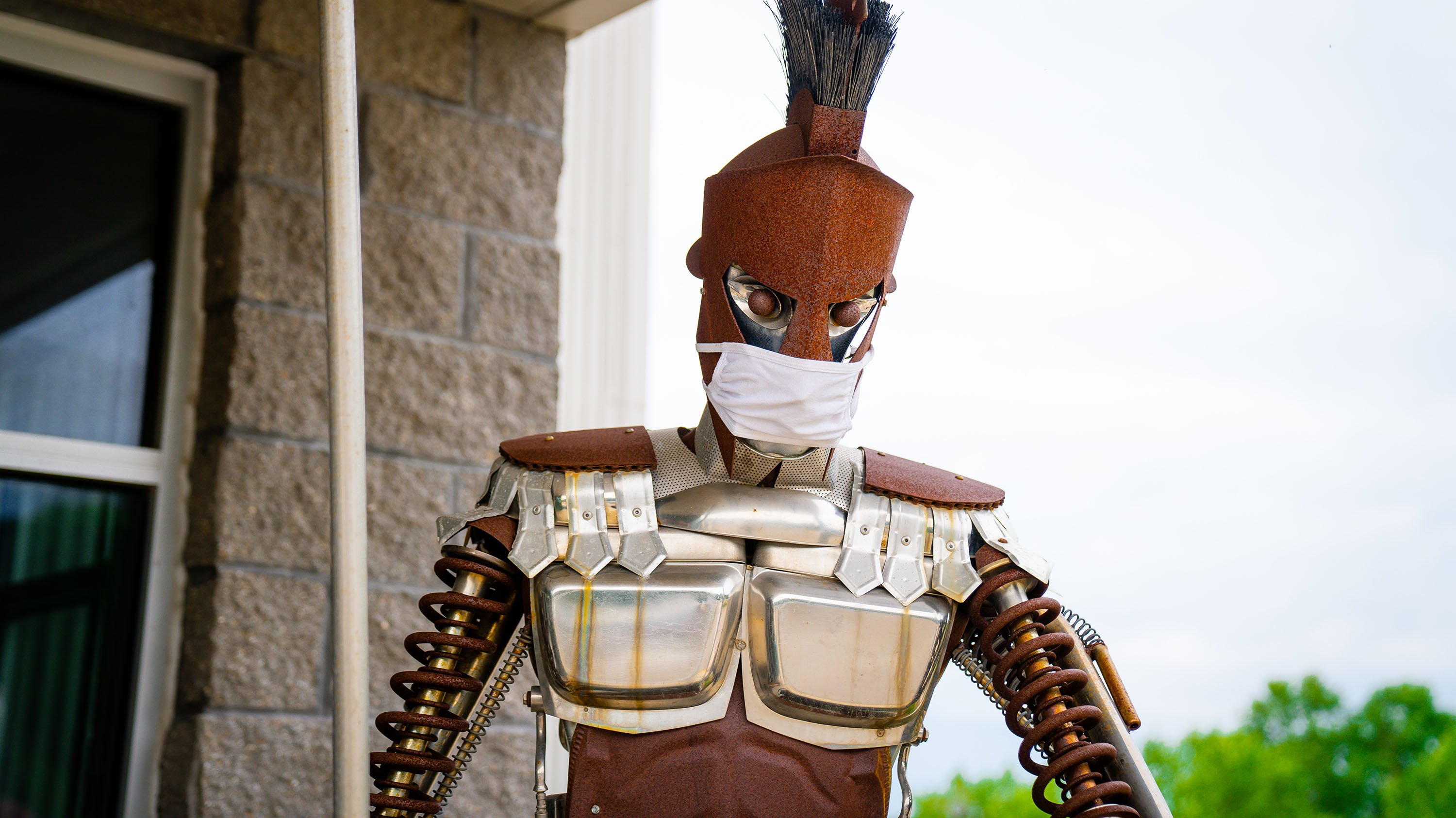 'Scrap Metal Sparty', a sculpture made out of recycled goods, wearing a mask