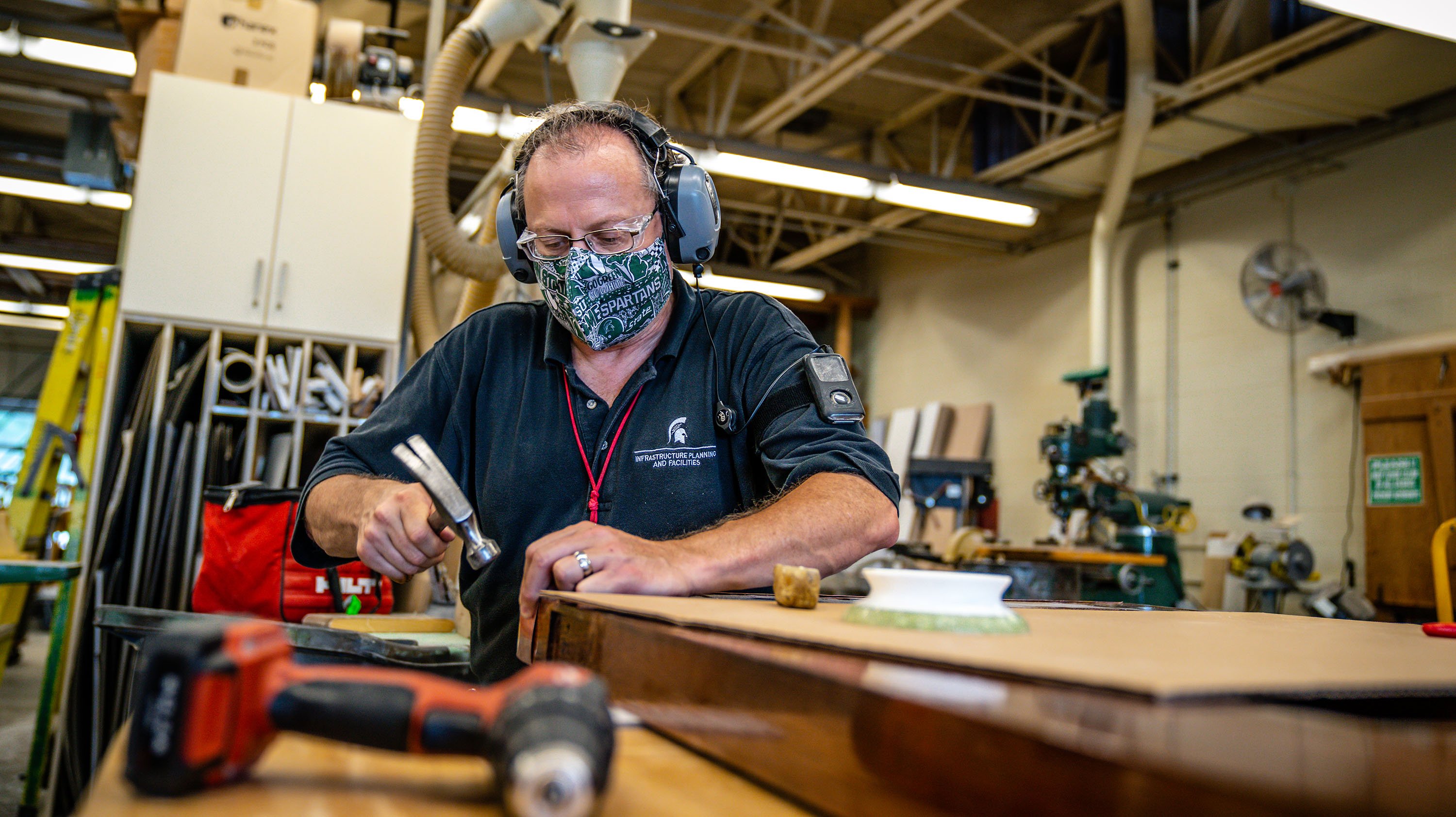 IPF carpenter Steve Rondeau working on one of the MSU Auditorium doors