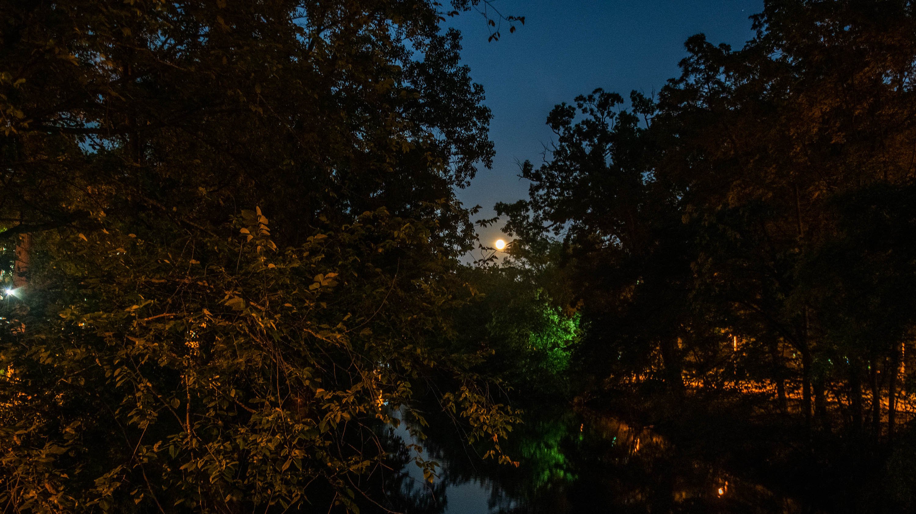 Moon over the red cedar river at night