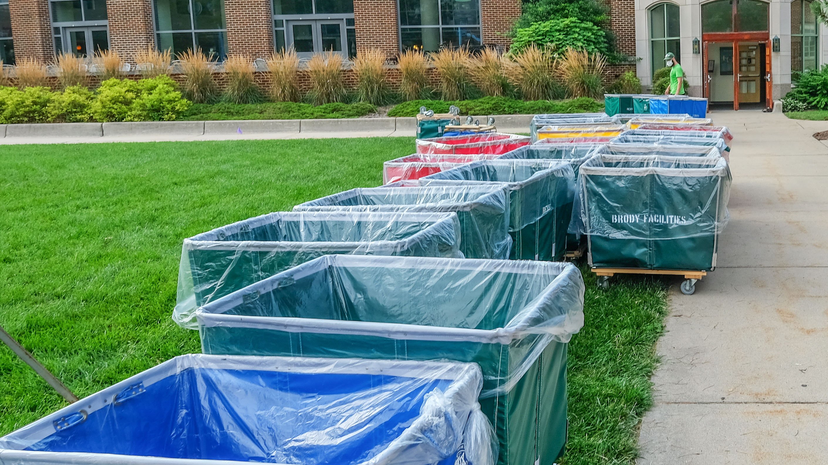Laundry carts, lined with plastic, outside Snyder Hall.