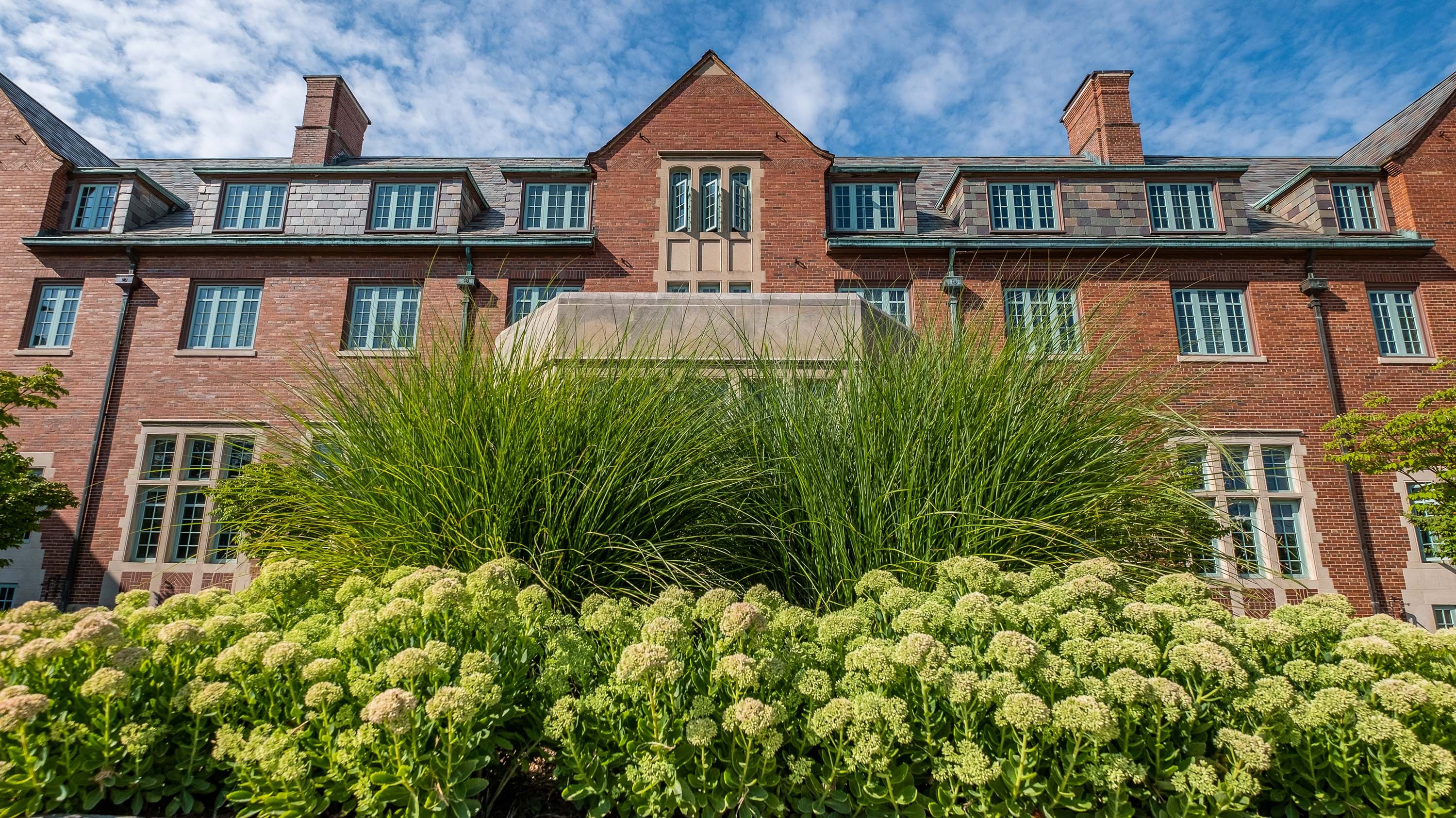 Landon Hall, behind green foliage