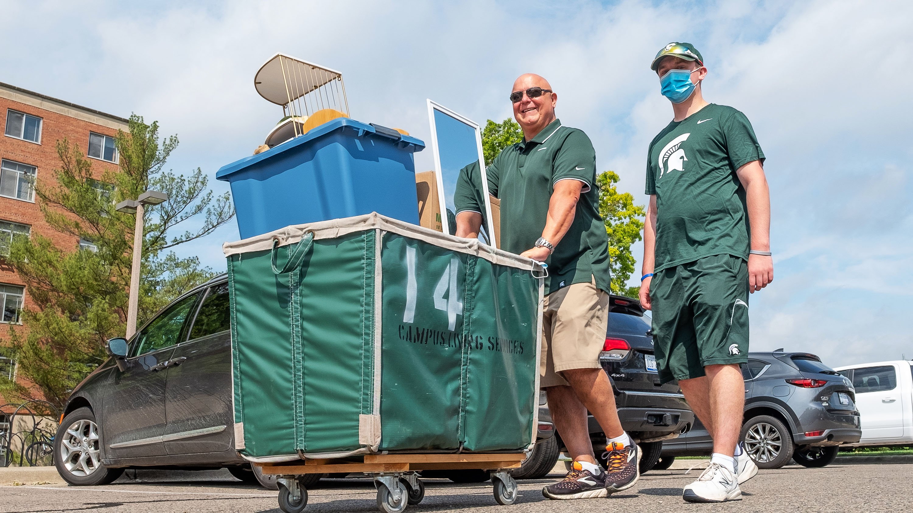 Family with laundry cart during move-in