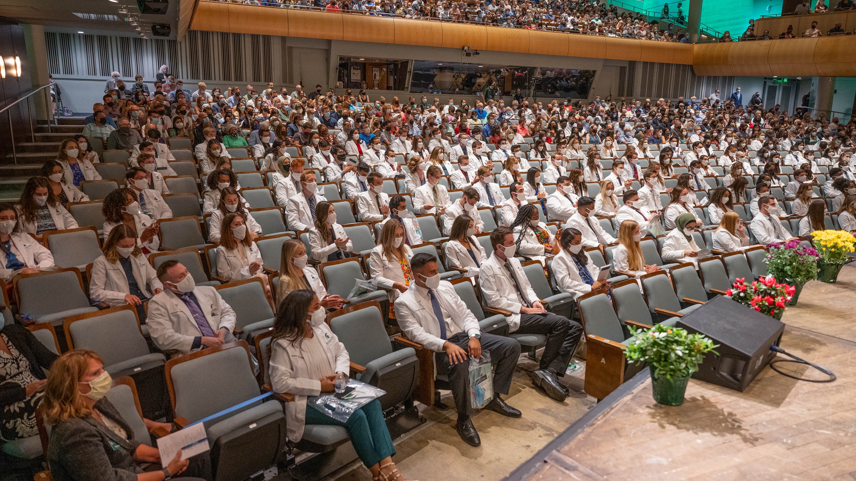 College of Human Medicine students sitting in a theater during their white coat ceremony