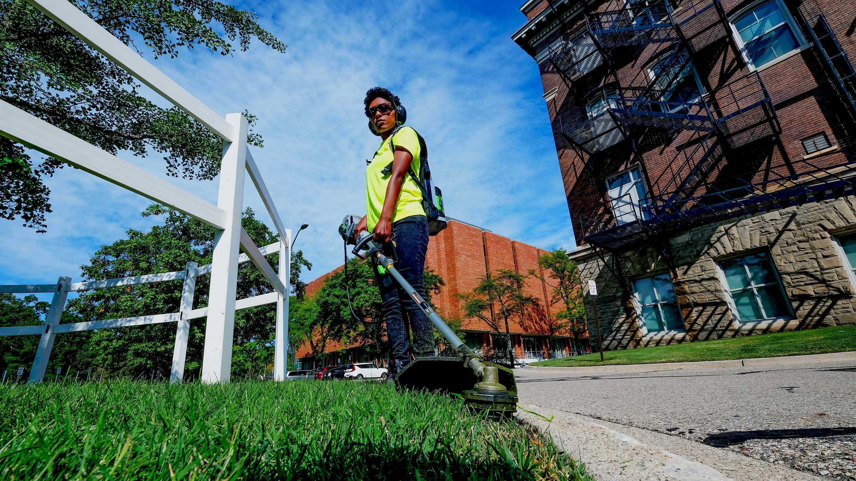 Marisha Curtis trimming grass near Olds Hall