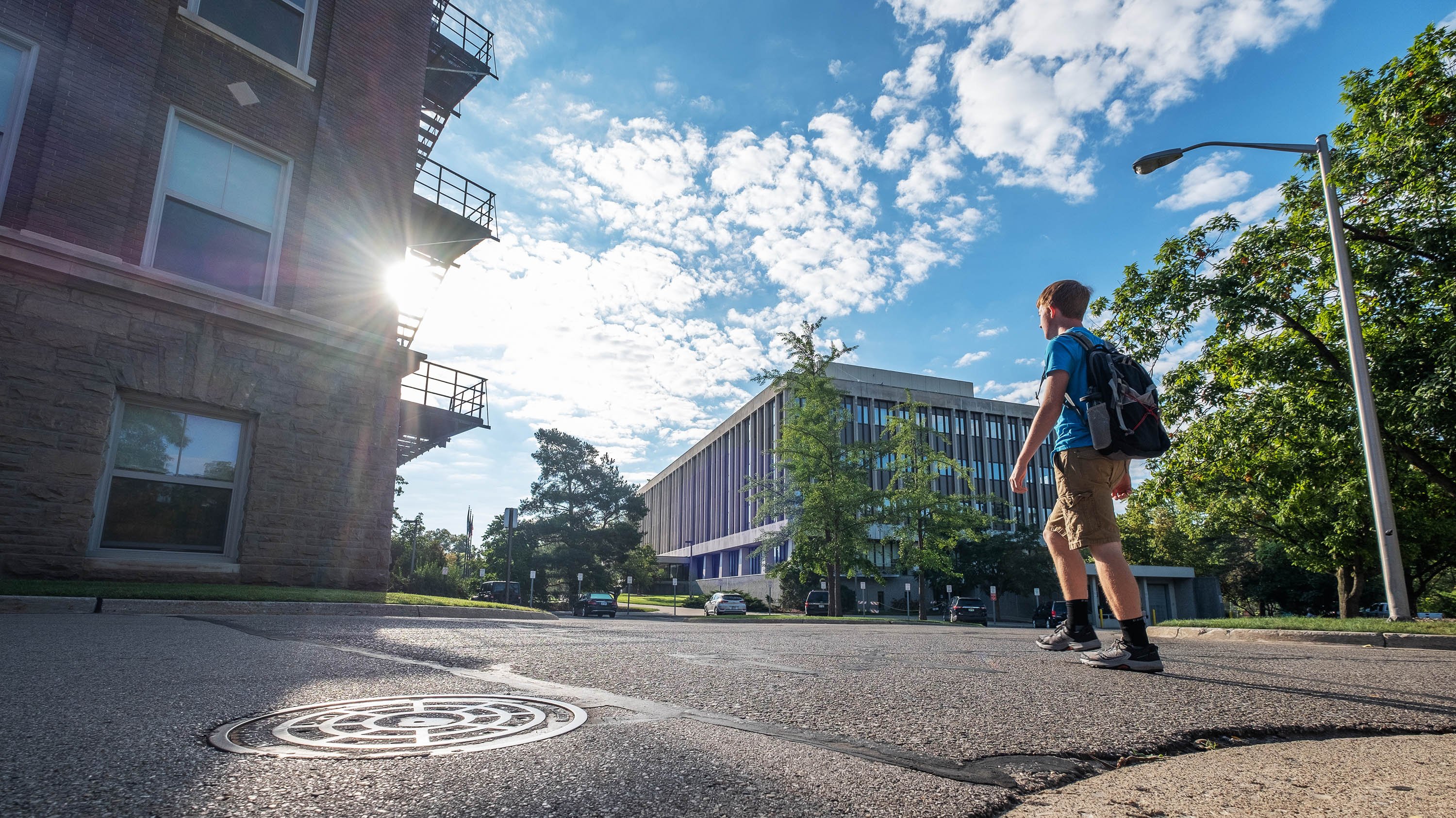 Student walking behind Olds Hall