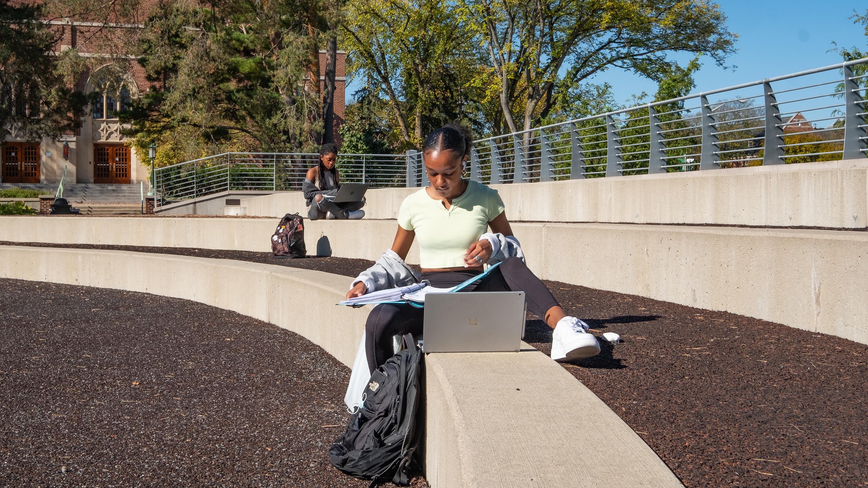 Two students studying outside Kresge Art Center