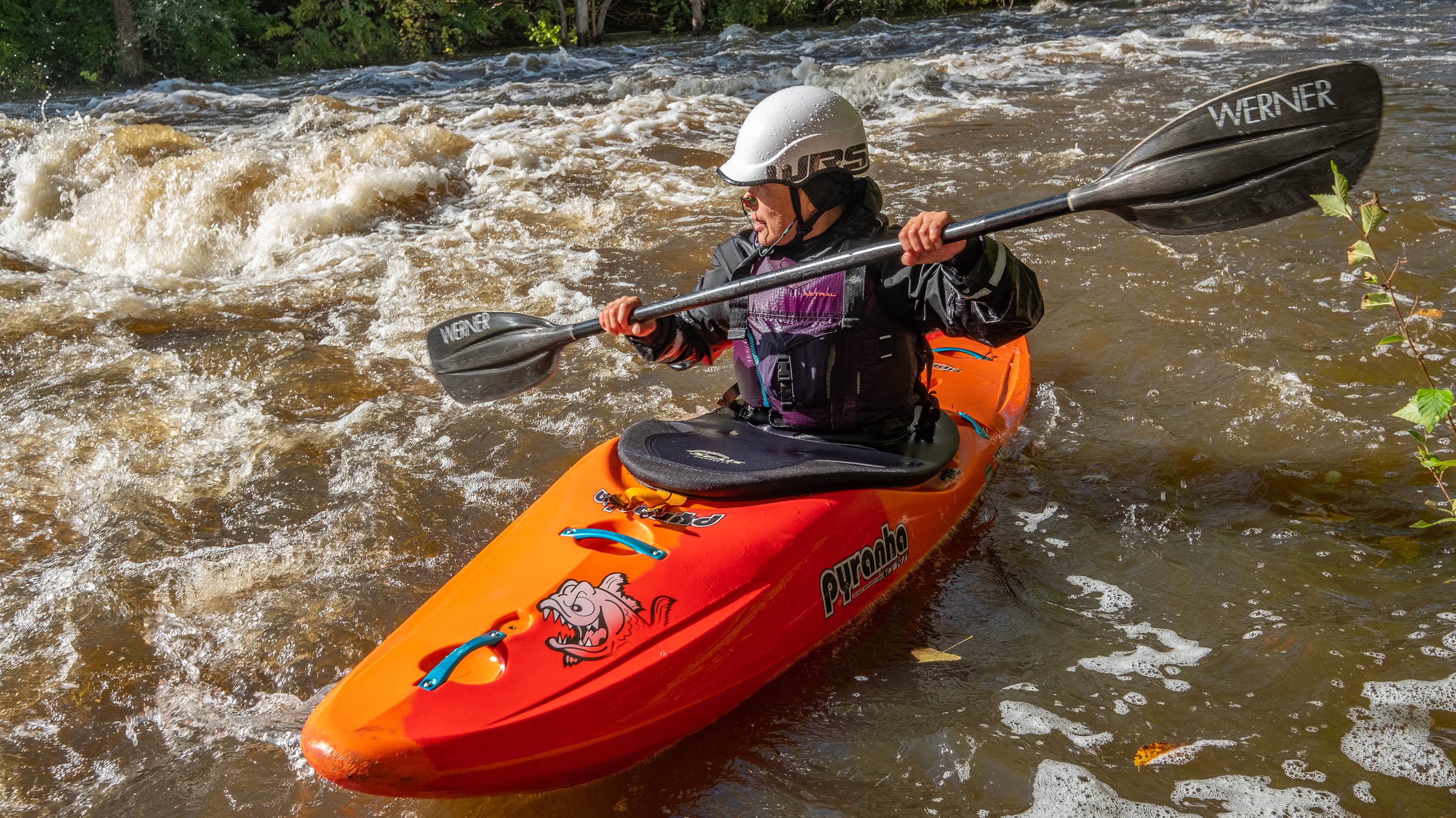 Person kayaking in the Red Cedar river