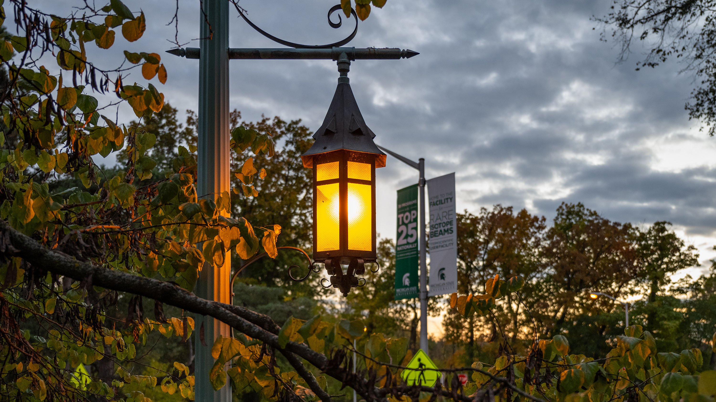 An MSU lantern glowing on a cloudy evening