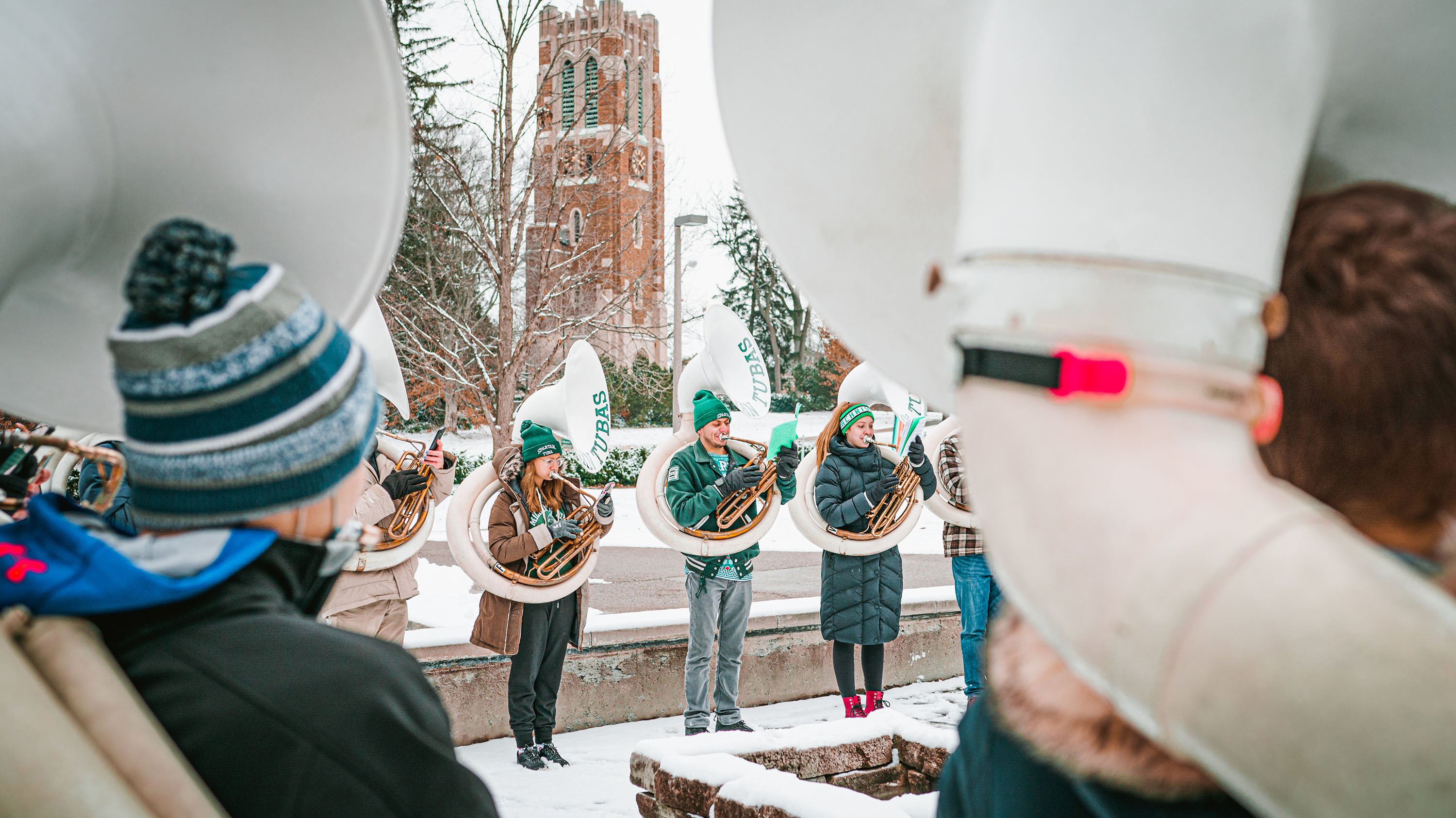 Spartan Tuba players performing in front of Beaumont Tower