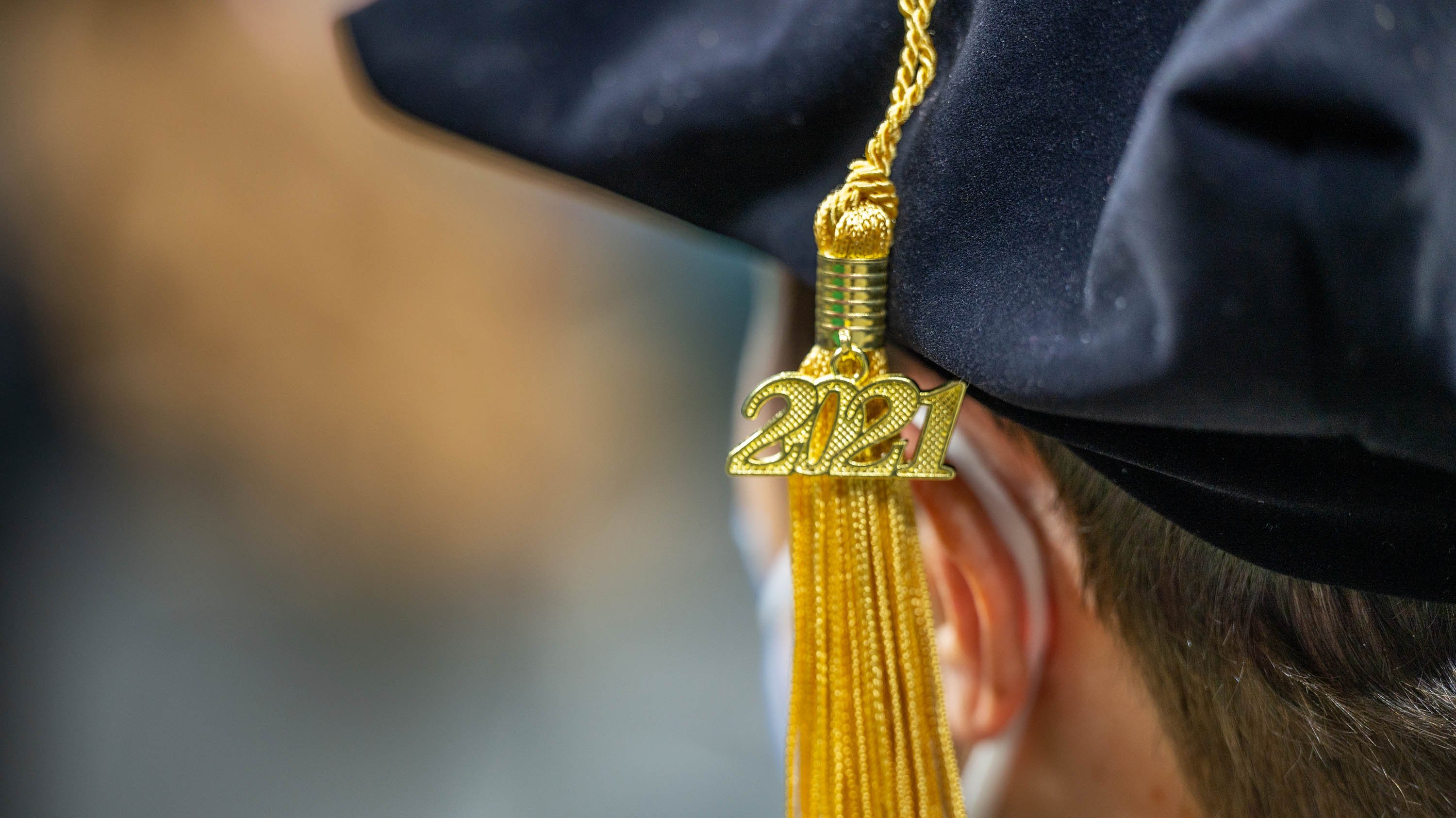 2021 charm on the tassel of an advanced degree recipient at the fall 2021 commencement ceremony