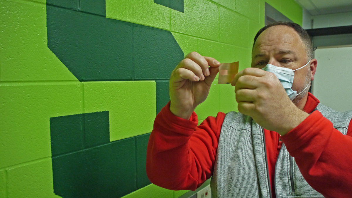 MSU Professor Andrew Mason holds a flexible electronic circuit designed by his lab