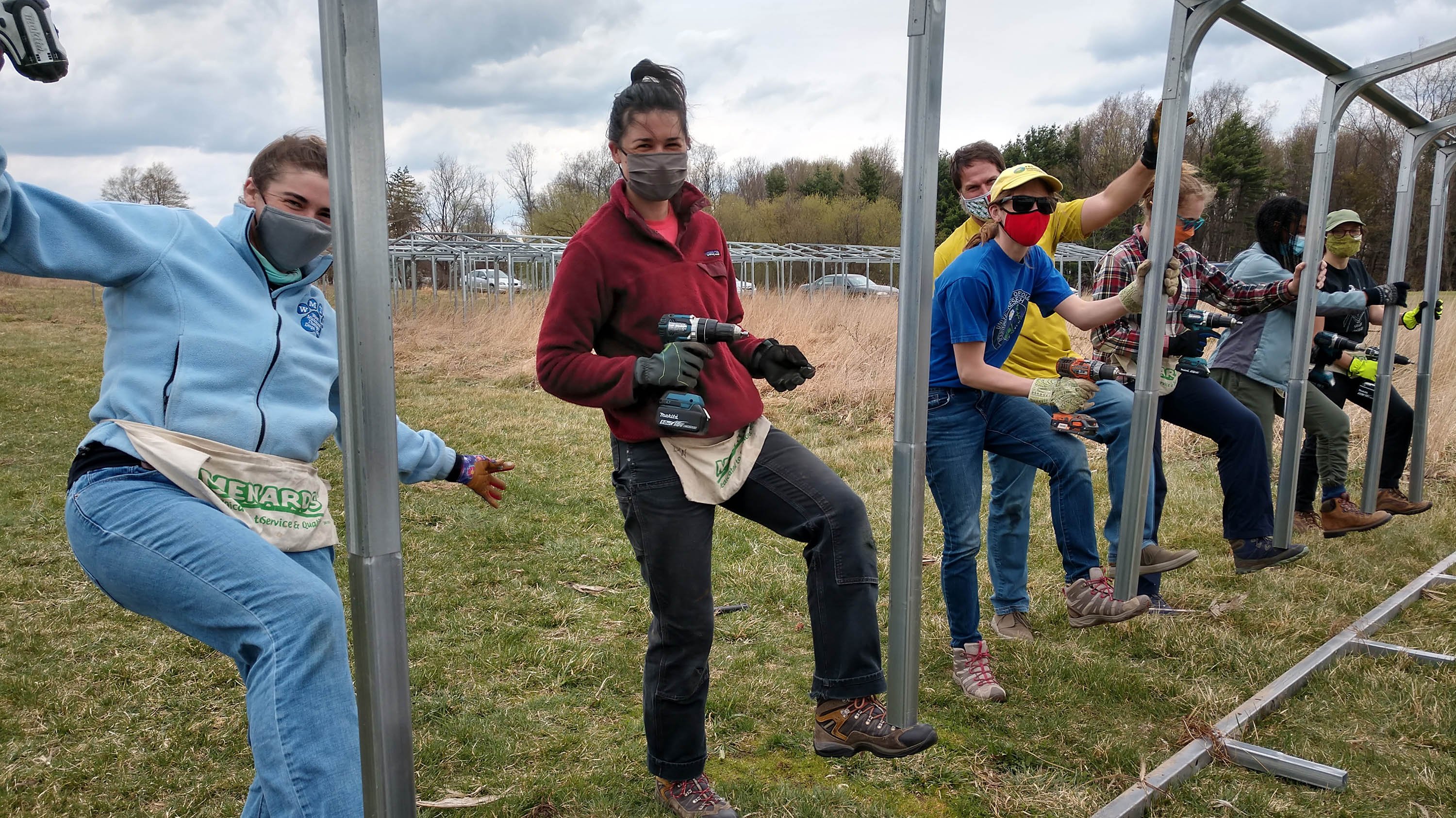 Members of the Haddad research lab installing one of the rain out shelters