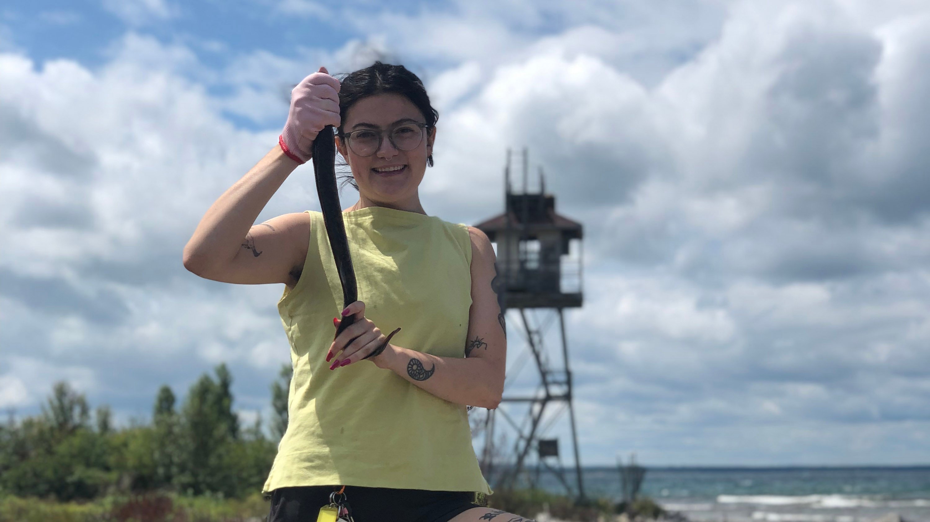 Emily Mensch holding up a sea lamprey