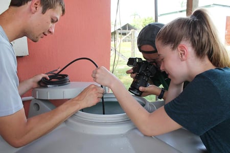 Ryan Zieglerand Medeline Labelle check water quality