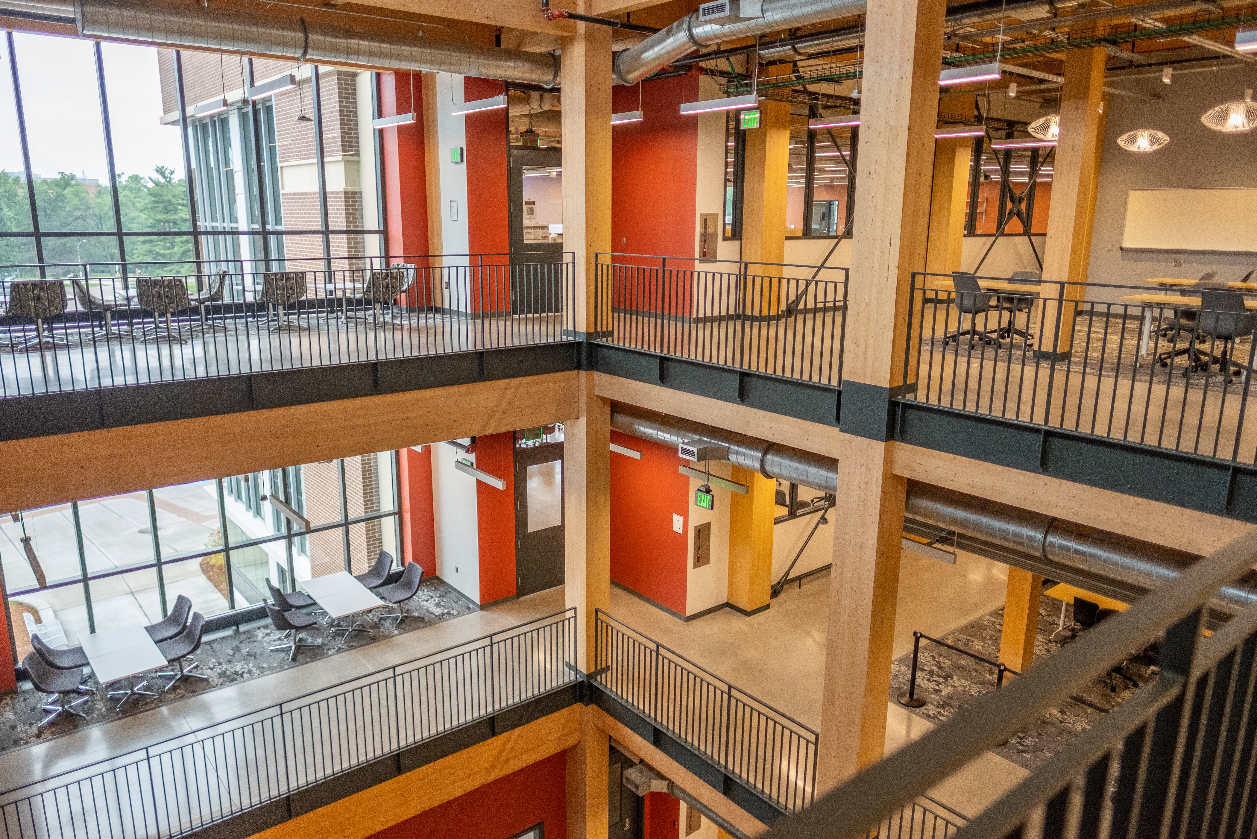 A photograph of the lobby of the new STEM Teaching and Learning Facility shows exposed mass timber, steel supports and windows.
