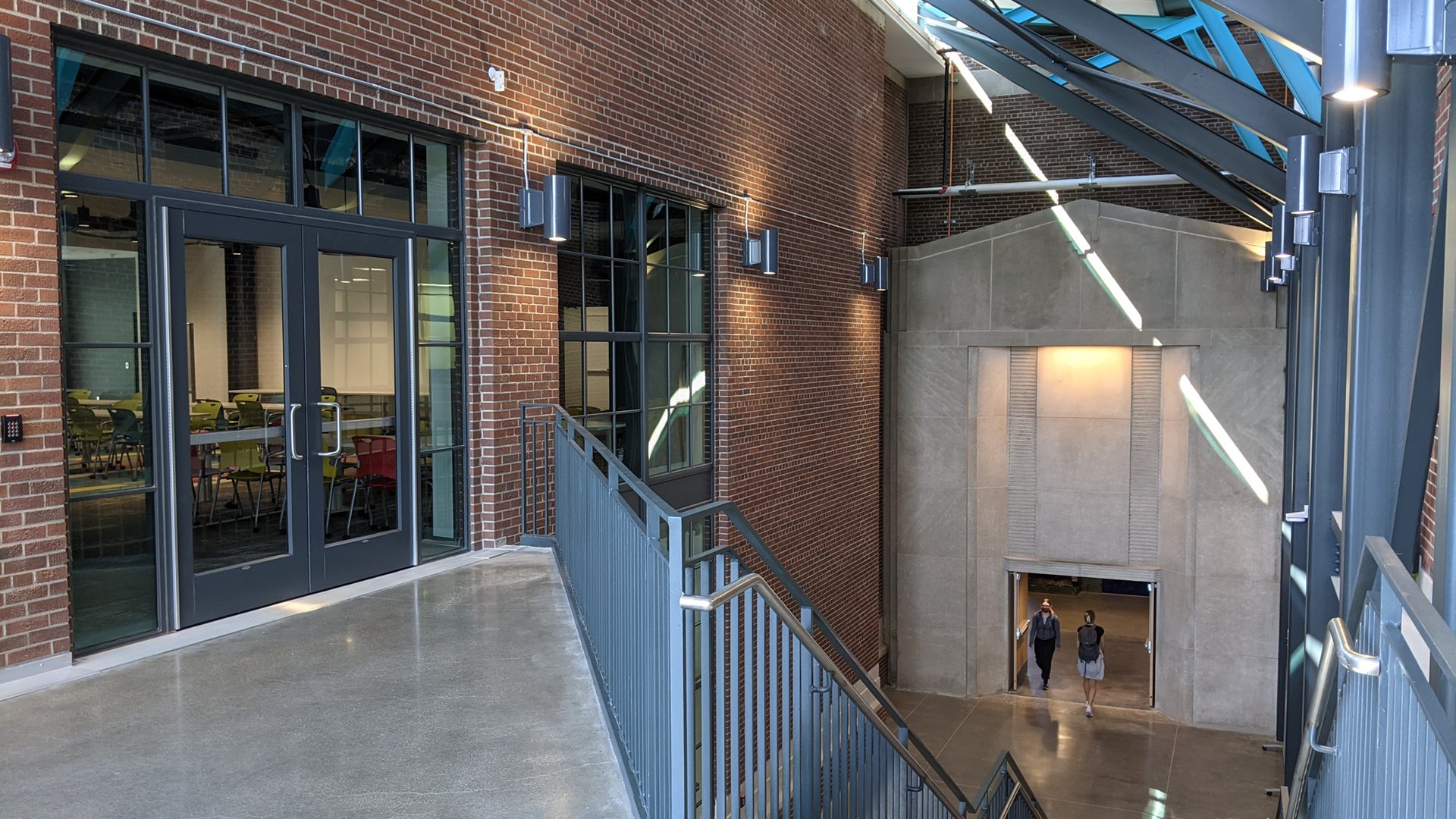 A photo shows a pale stone entrance surrounded by red brick in the atrium of the STEM Teaching and Learning Facility. This entrance was part of the original Shaw Lane Power Plant.