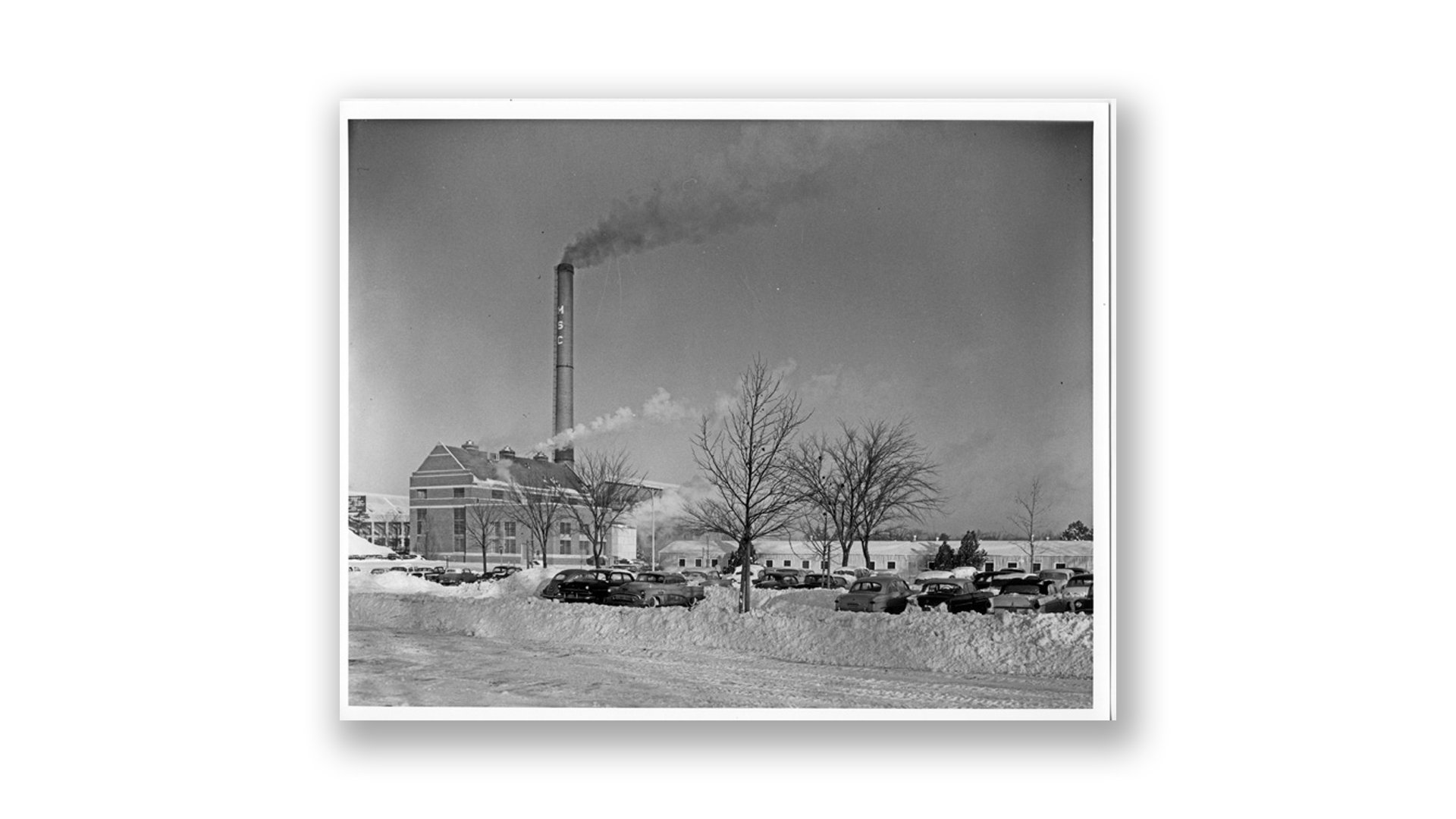 A black-and-white photo from 1959 shows the Shaw Lane Power Plant on a clear, snowy day.