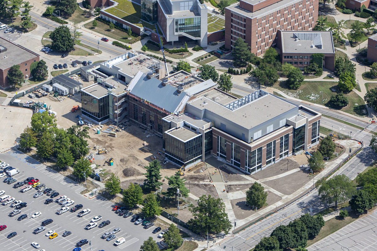 An aerial photo of the taken in 2018 shows how the Shaw Lane Power Plant ? a red brick building with a grayish-blue roof ? was integrated into the larger STEM Teaching and Learning Facility