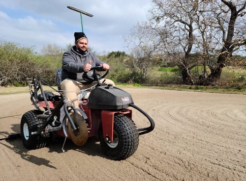 student Trevor Stahl on riding maintenance equipment