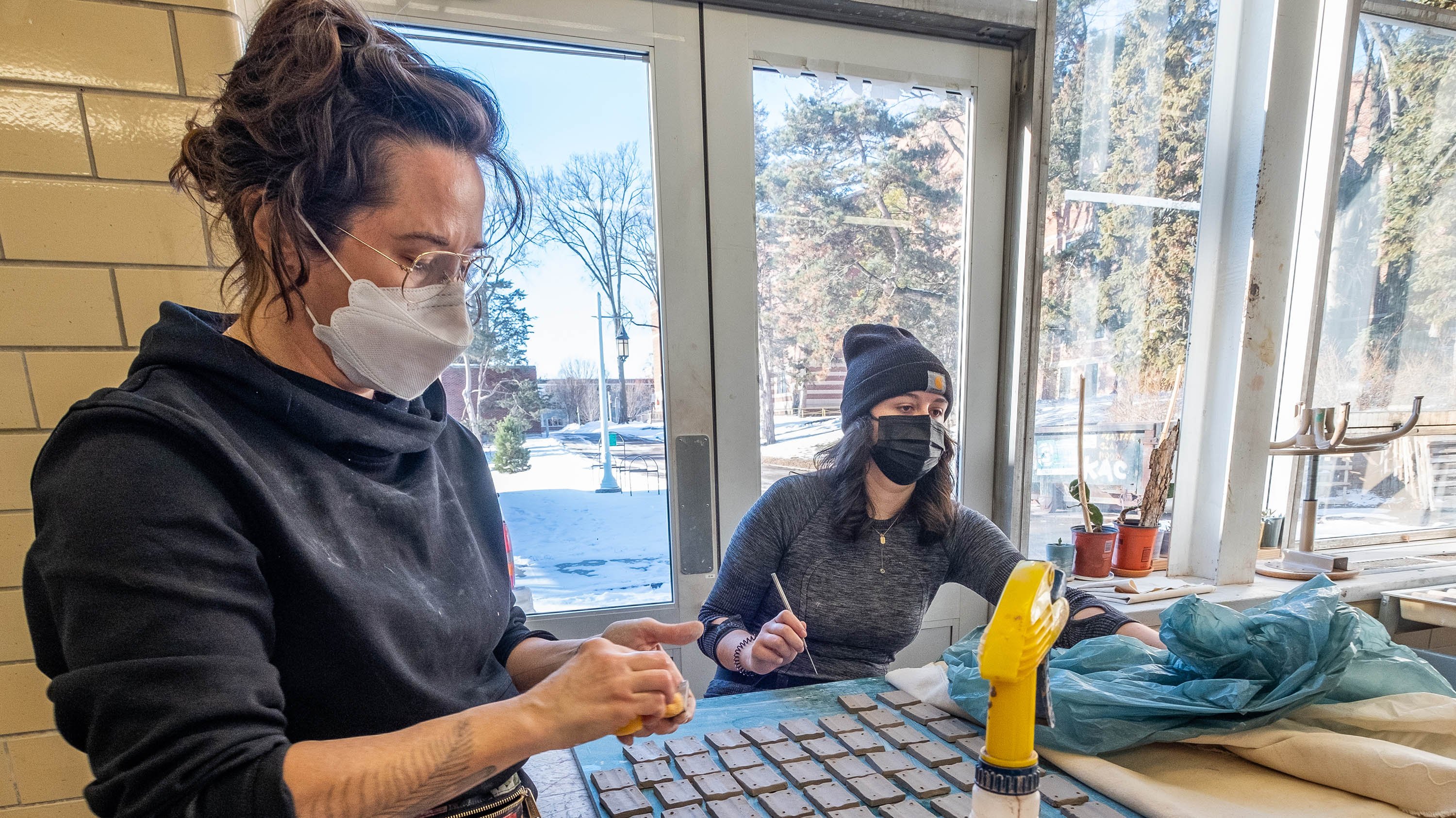 Artist in residence Dan Paz prepares artwork with student Jessie Gott