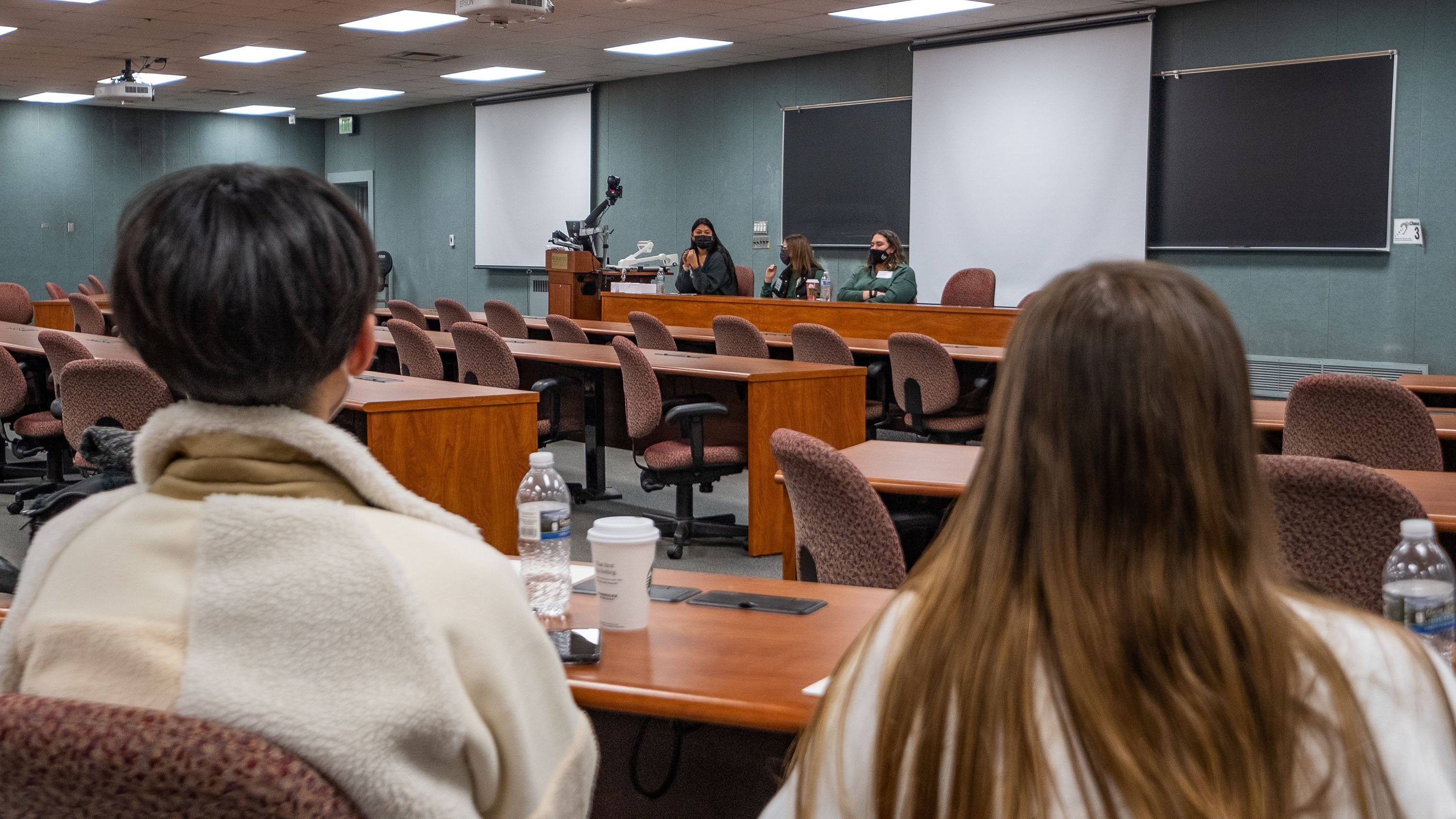 Two students watching a presentation at International student orientation
