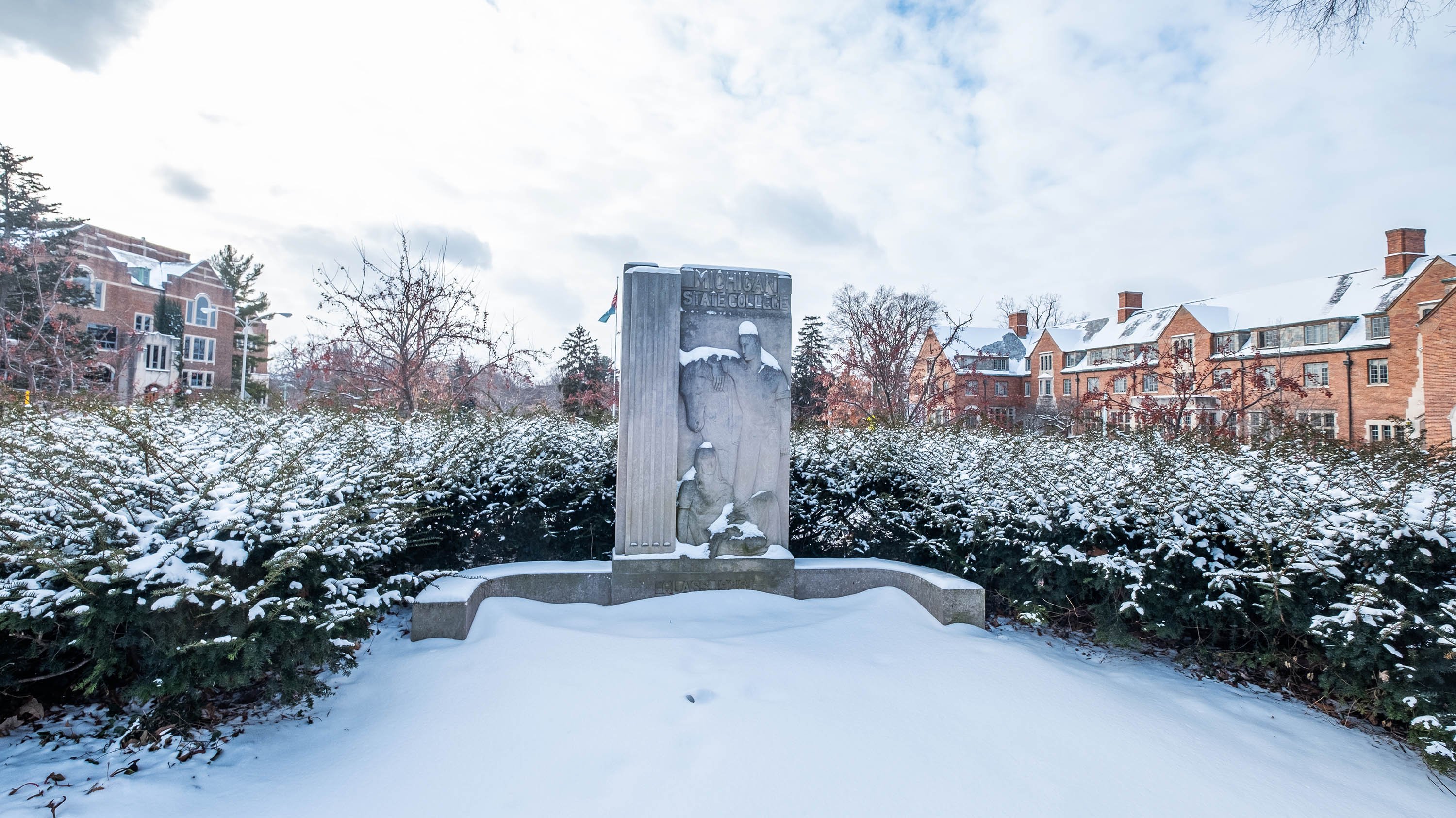Limestone sign by Samuel Cashwan at the Abbott and Grand River entrance to campus