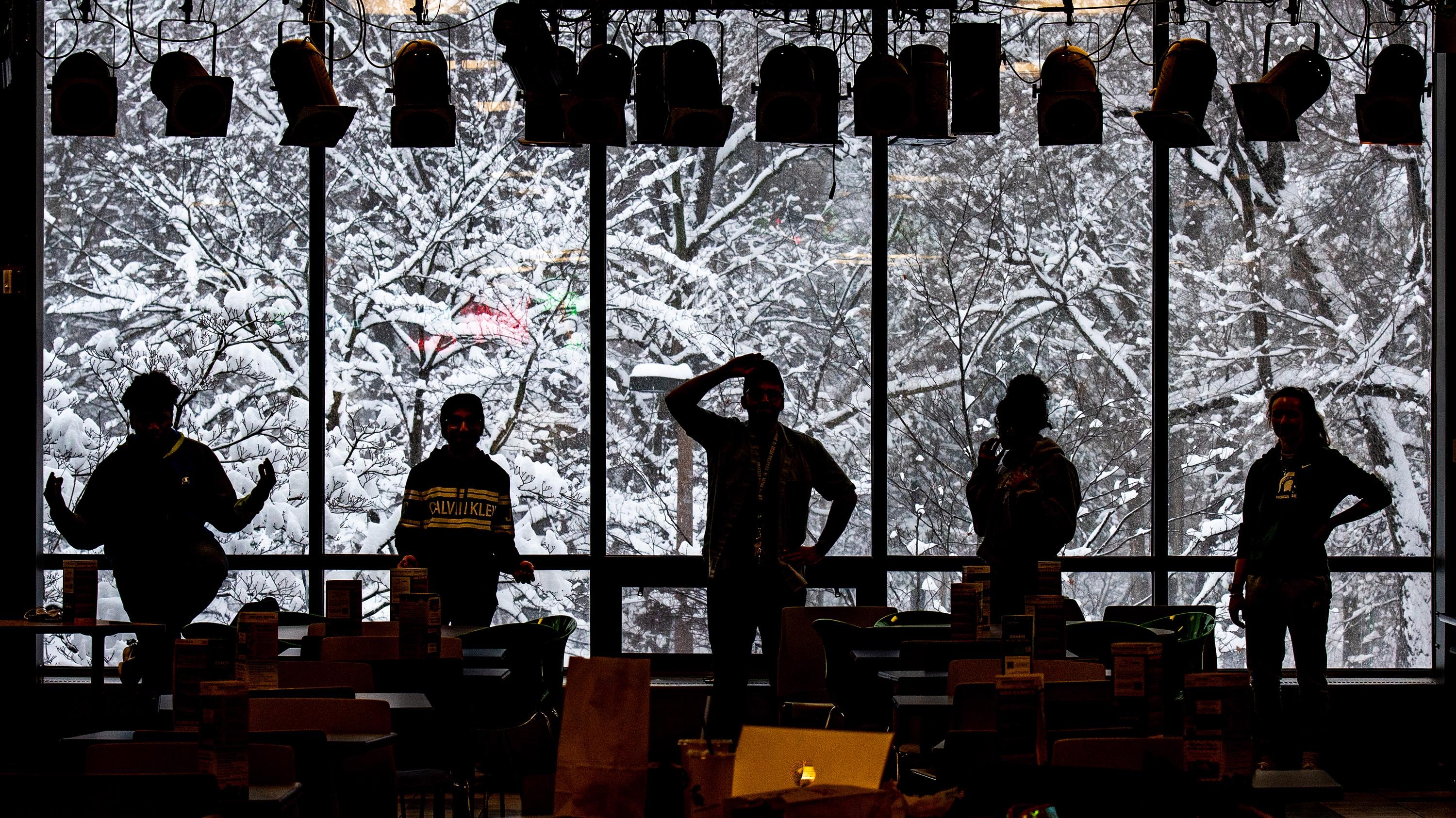 Silhouette of students posing in the Crossroads Food Court