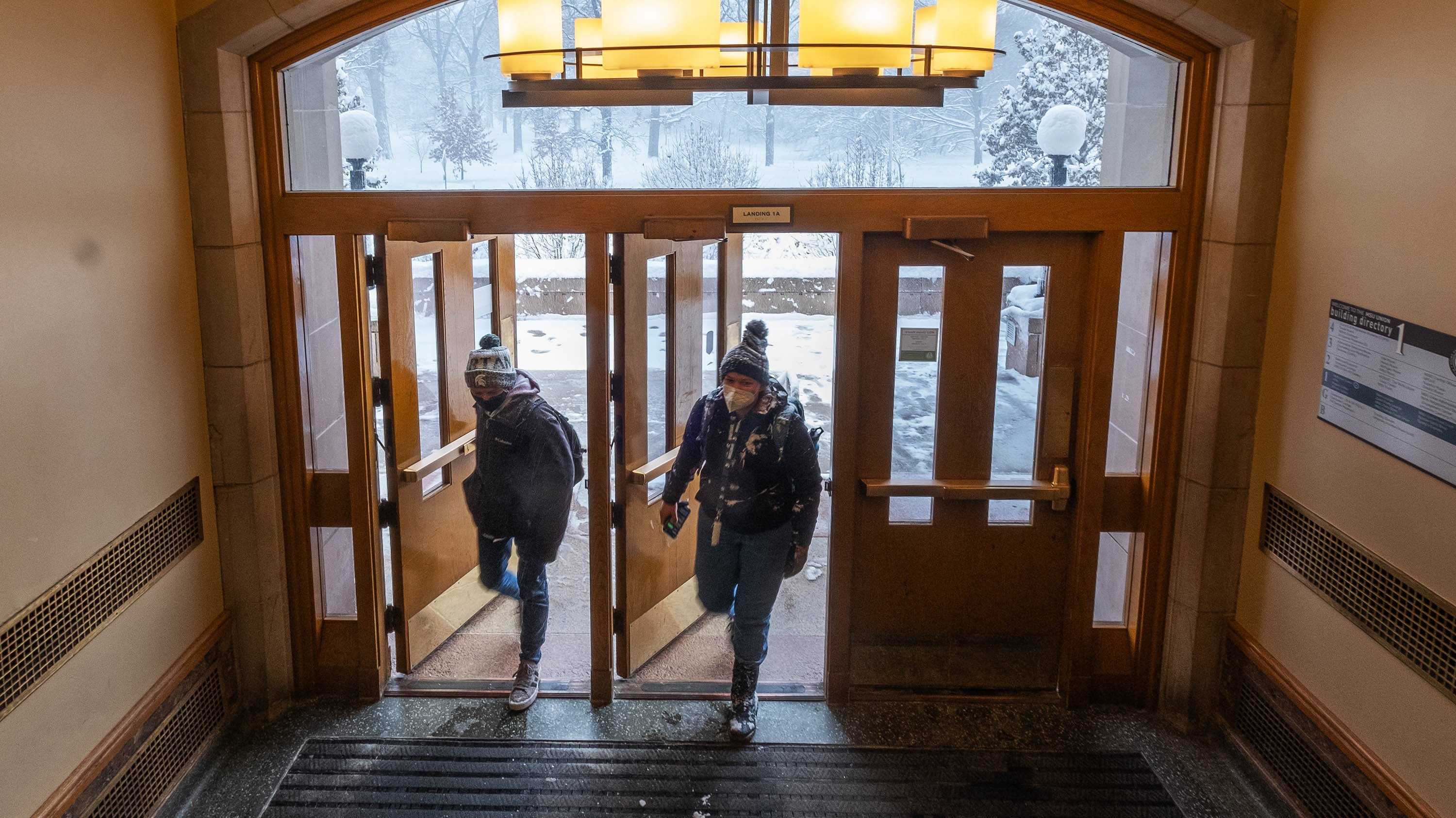 Two students walking in the Union entrance