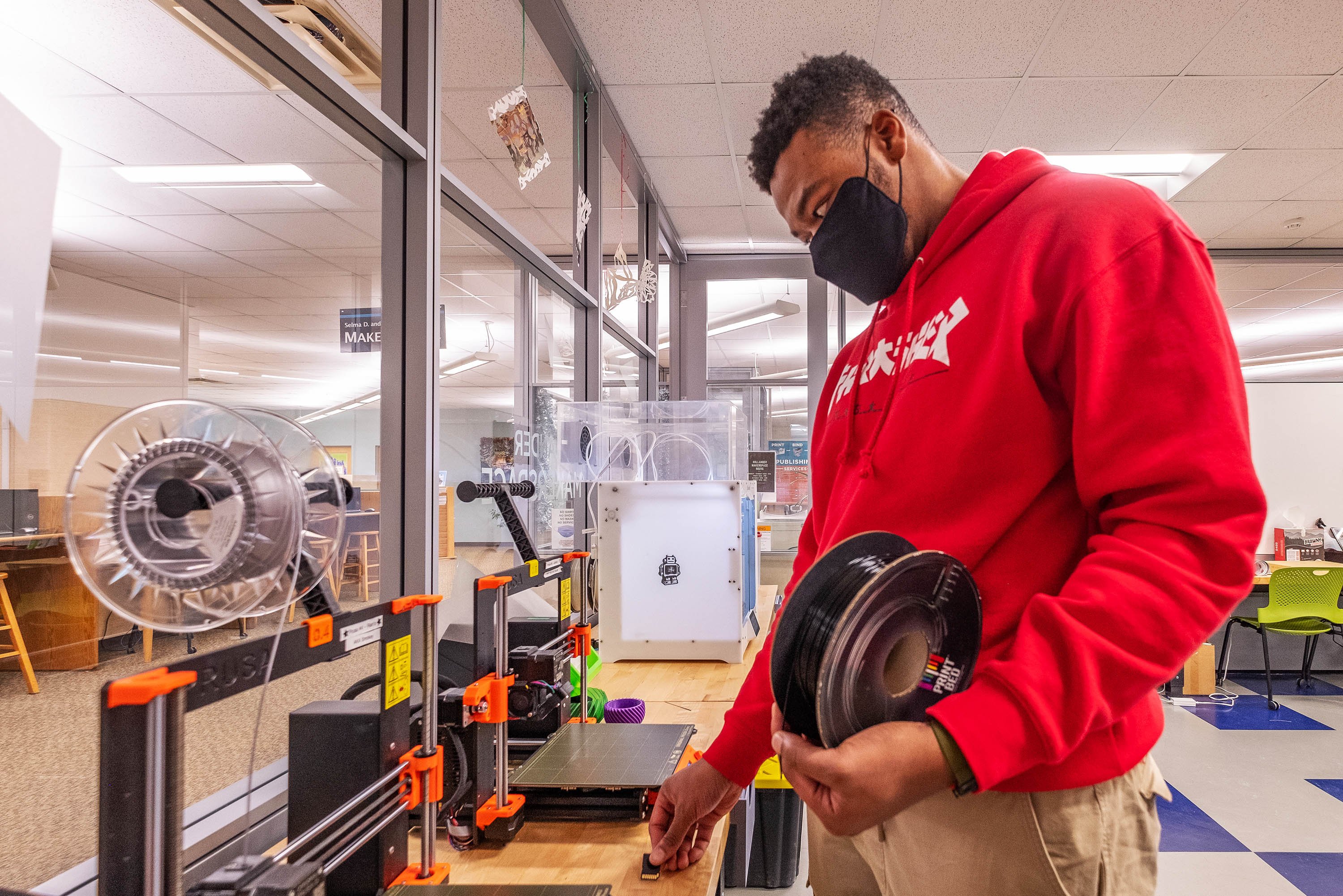 Student using 3D printer in MakeCentral Makerspace
