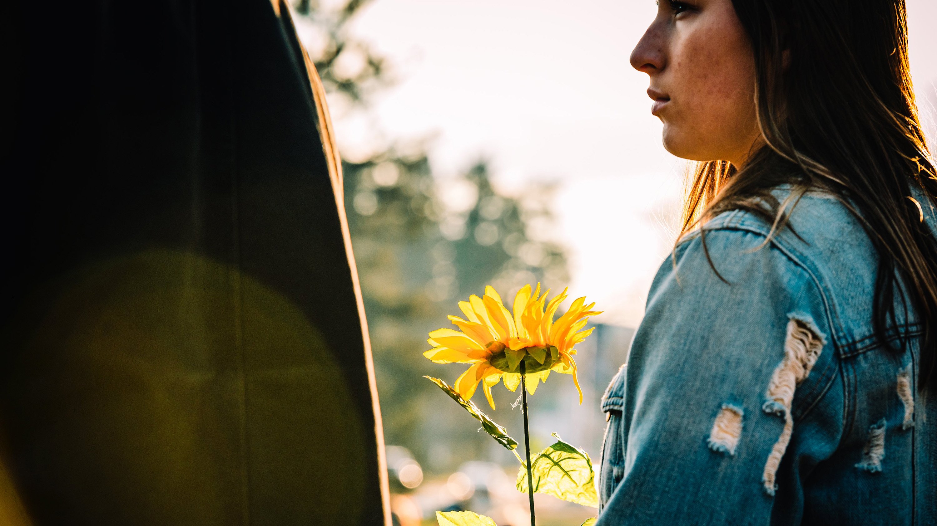 Woman holding sunflower at rally for peace in Ukraine